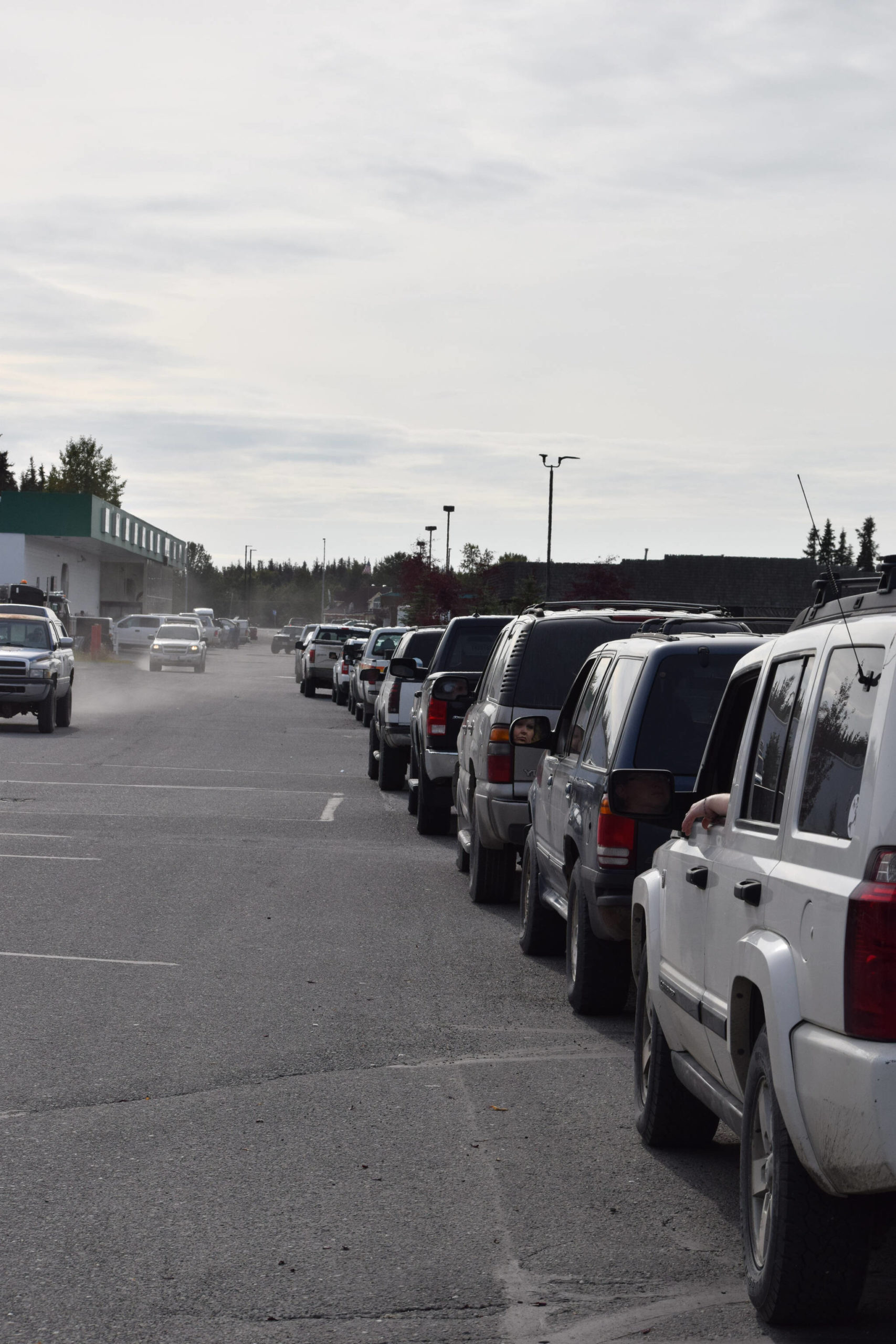 Cars line up outside of Capstone Clinic’s COVID-19 testing site in Kenai, Alaska on Tuesday, Sept. 7, 2021. The line extended through the Three Bears Grocery parking lot, and past the entrances to O’Reilly Auto Parts and Aspen Extended Stay Suites. Some said they waited for three and a half hours to get tested, and others said the line stretched down and around Walker Lane Tuesday morning. (Camille Botello/Peninsula Clarion)