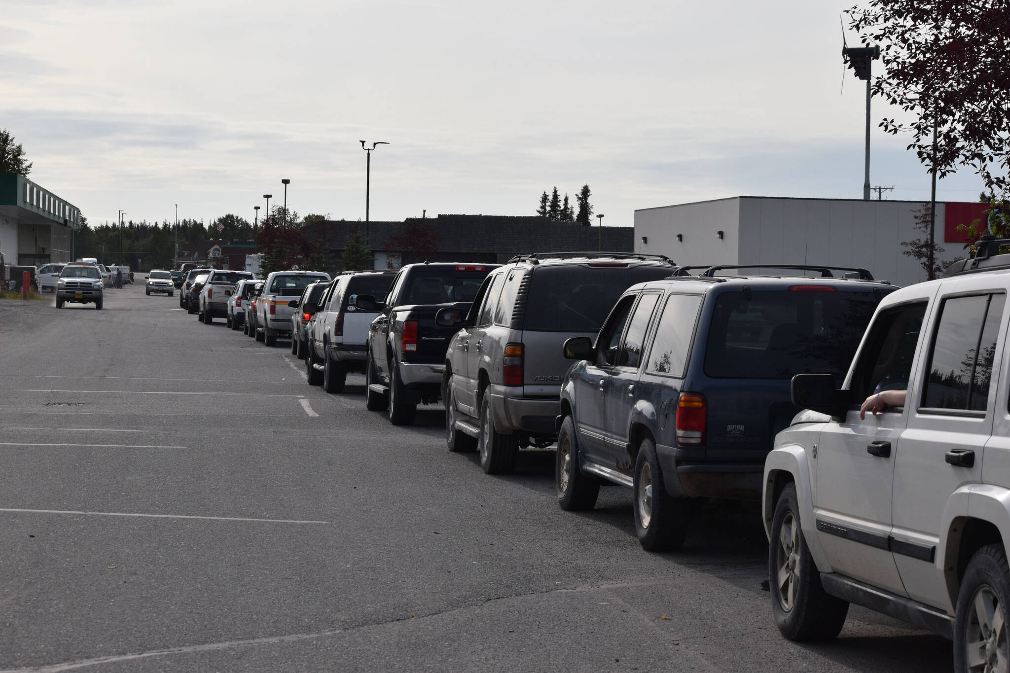 Cars line up outside of Capstone Clinic’s COVID-19 testing site in Kenai, Alaska on Tuesday, Sept. 7, 2021. The line extended through the Three Bears Grocery parking lot, and past the entrances to O’Reilly Auto Parts and Aspen Extended Stay Suites. Some said they waited for three and a half hours to get tested, and others said the line stretched down and around Walker Lane Tuesday morning. (Camille Botello/Peninsula Clarion)