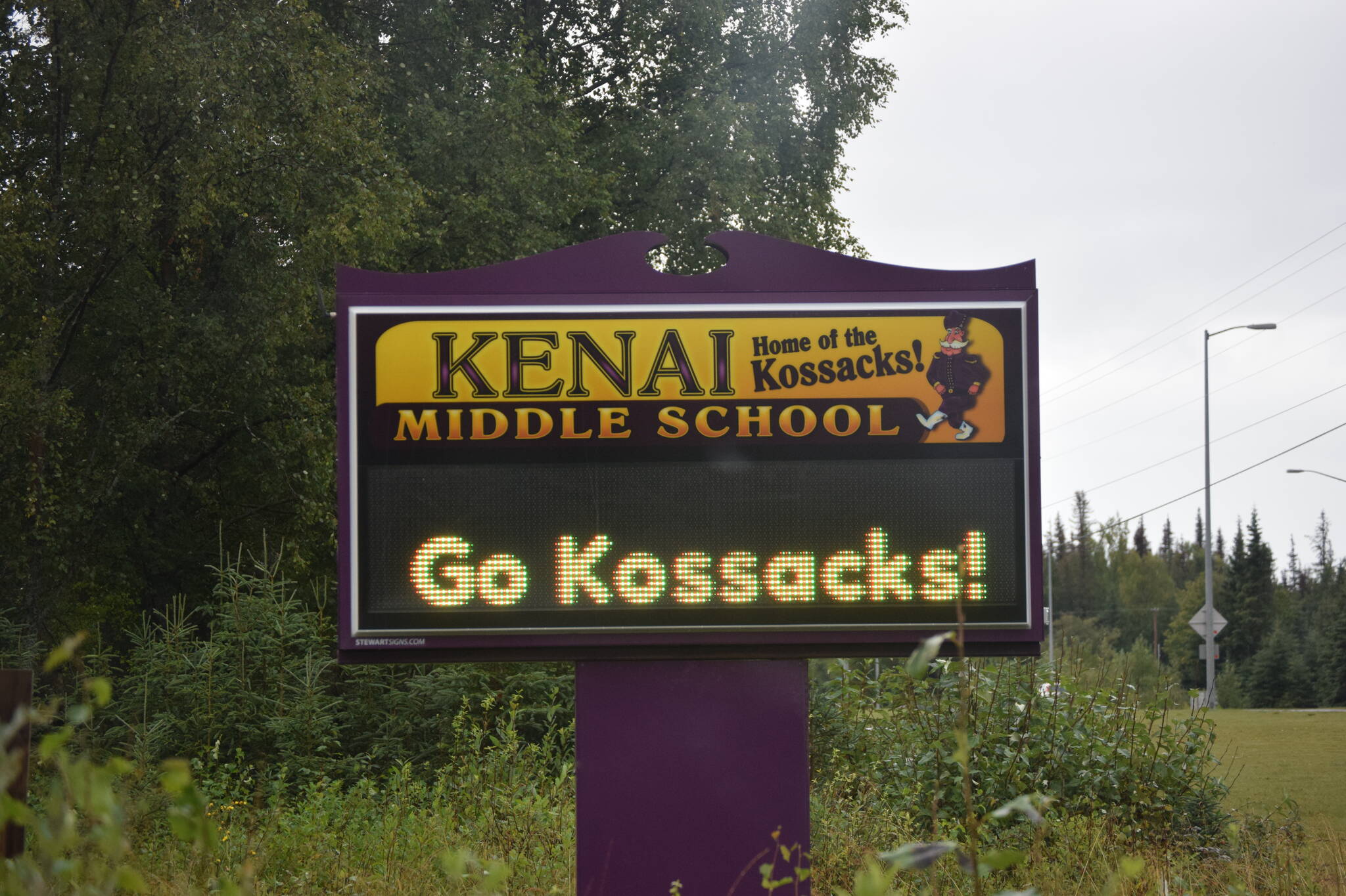 A sign in front of Kenai Middle School is seen on Sept. 2, 2021, in Kenai, Alaska. The school was one of more than a dozen Kenai Peninsula Borough School District schools operating with universal indoor masking due to rising COVID-19 cases. (Photo by Jeff Helminiak/Peninsula Clarion)