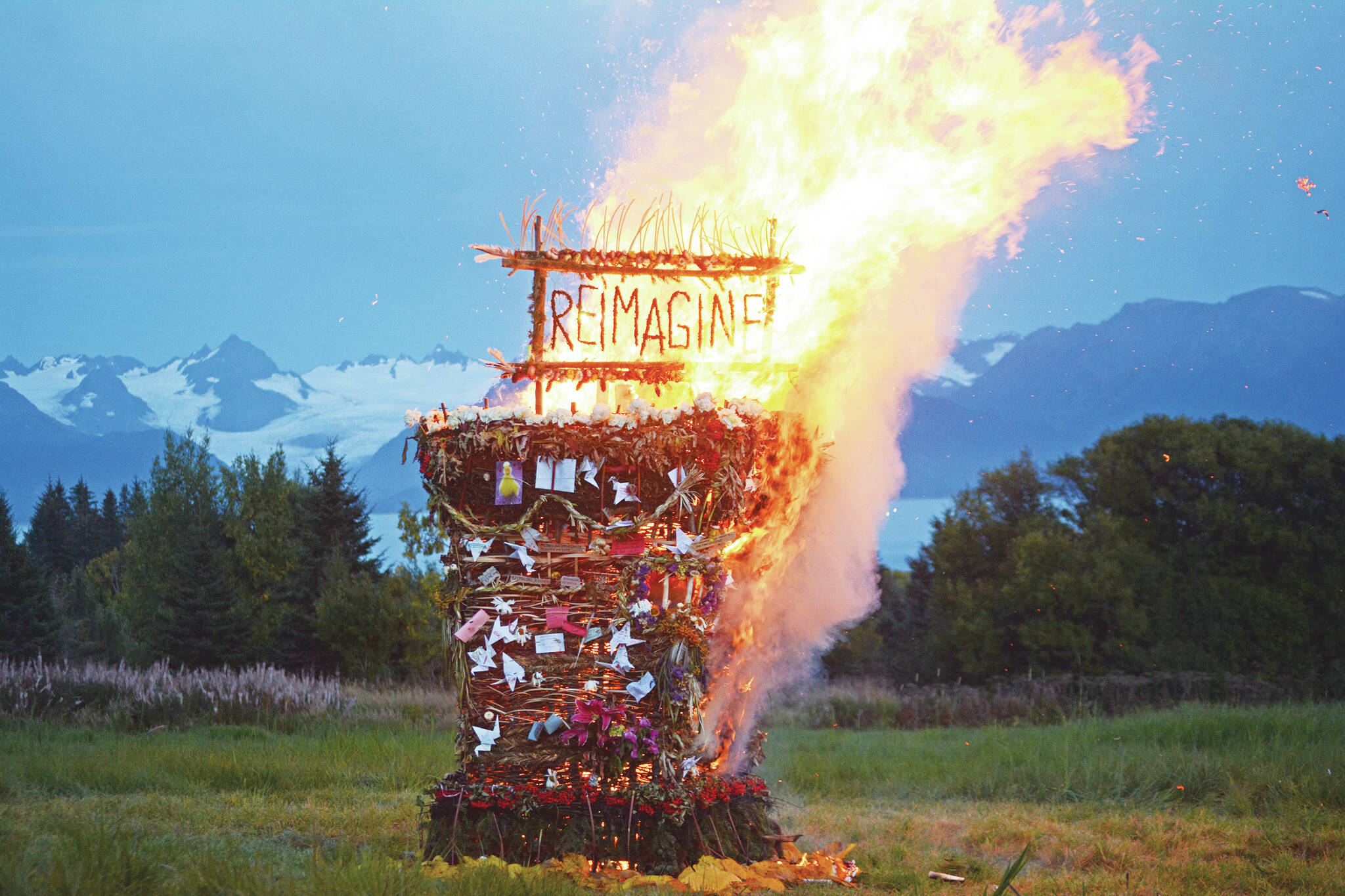 “Reimagine,” the 17th annual Burning Basket, catches fire in a field on Sunday, Sept. 13, 2020, near Homer. Artist Mavis Muller intended to broadcast live on Facebook and YouTube the burning of the basket, but because of technical difficulties that didn’t happen. (Photo by Michael Armstrong/Homer News)