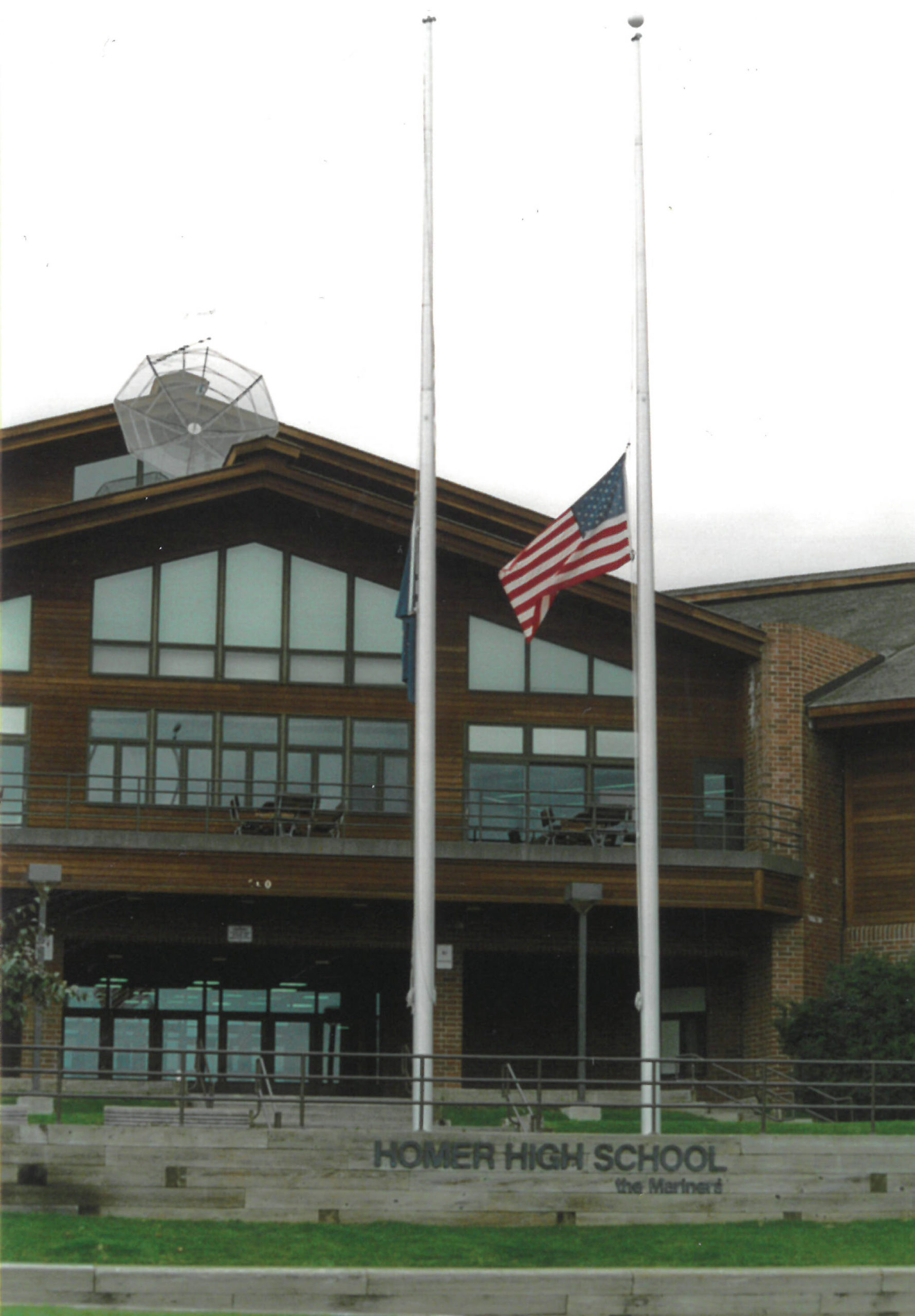 Flags fly at half-staff in front of Homer High School on Sept. 11, 2001, in memory of the victims of the attacks in New York, Washington, D.C., and in the air over Pennsylvania. (Homer News file photo)