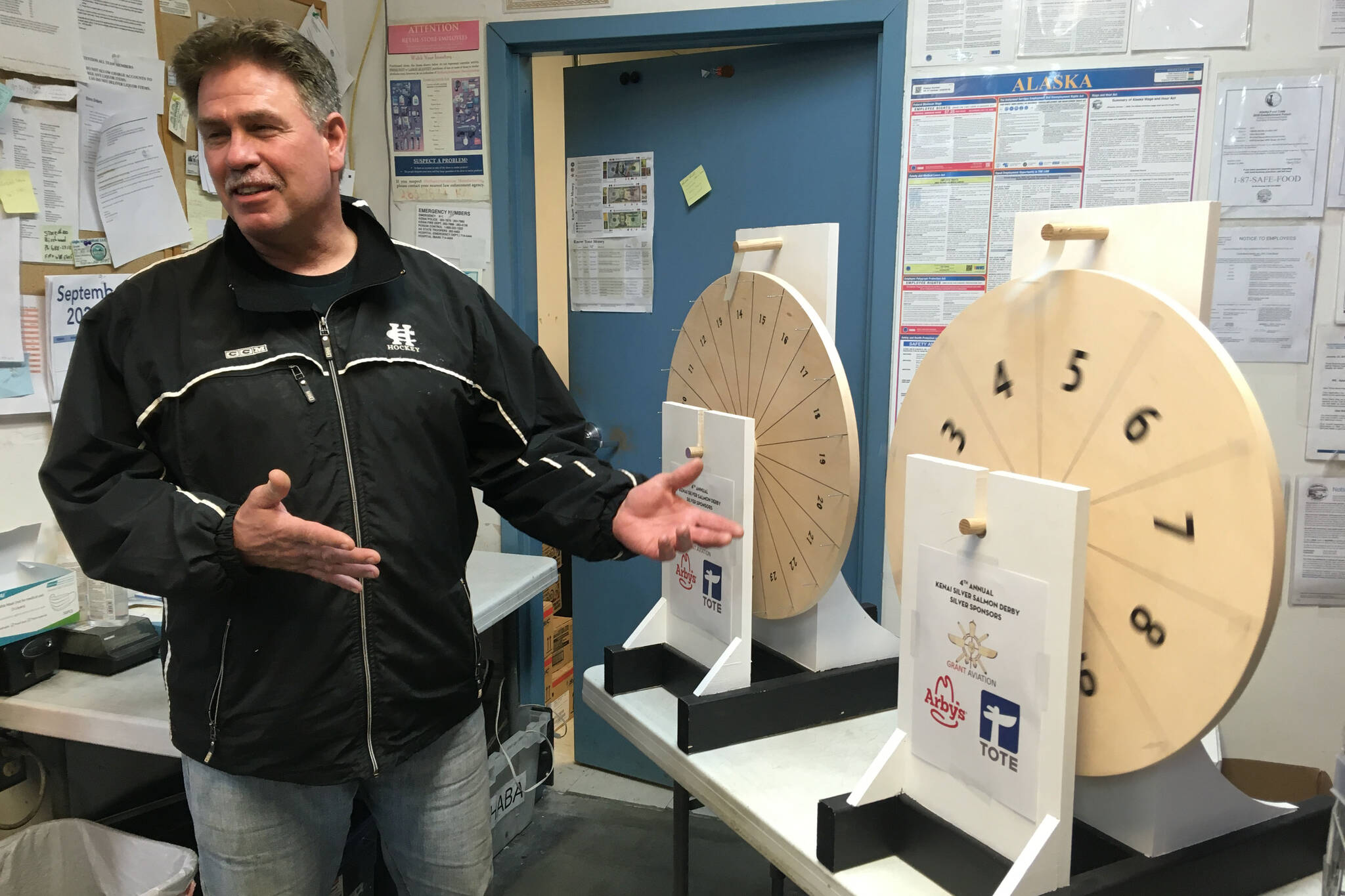 Kenai Mayor Brian Gabriel spins a wheel to determine the Magic Weight at the Kenai Silver Salmon Derby on Tuesday, Sept. 15, 2020, at Three Bears grocery store in Kenai, Alaska. (Photo by Jeff Helminiak/Peninsula Clarion)