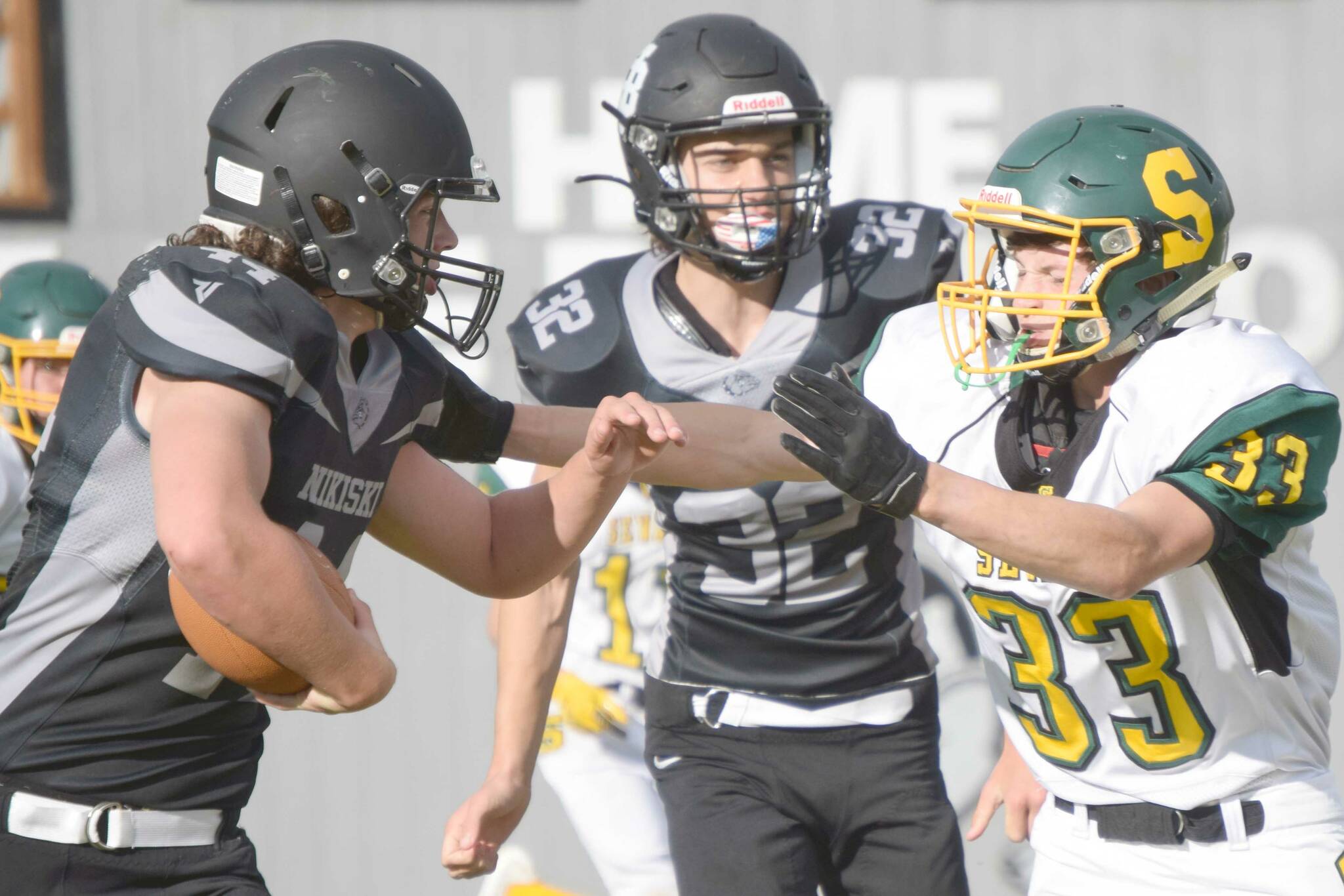 Nikiski's Truit McCaughey tries to run through the tackle of Seward's Gideon Schrock on Friday, Sept. 10, 2021, at Nikiski High School. (Photo by Jeff Helminiak/Peninsula Clarion)