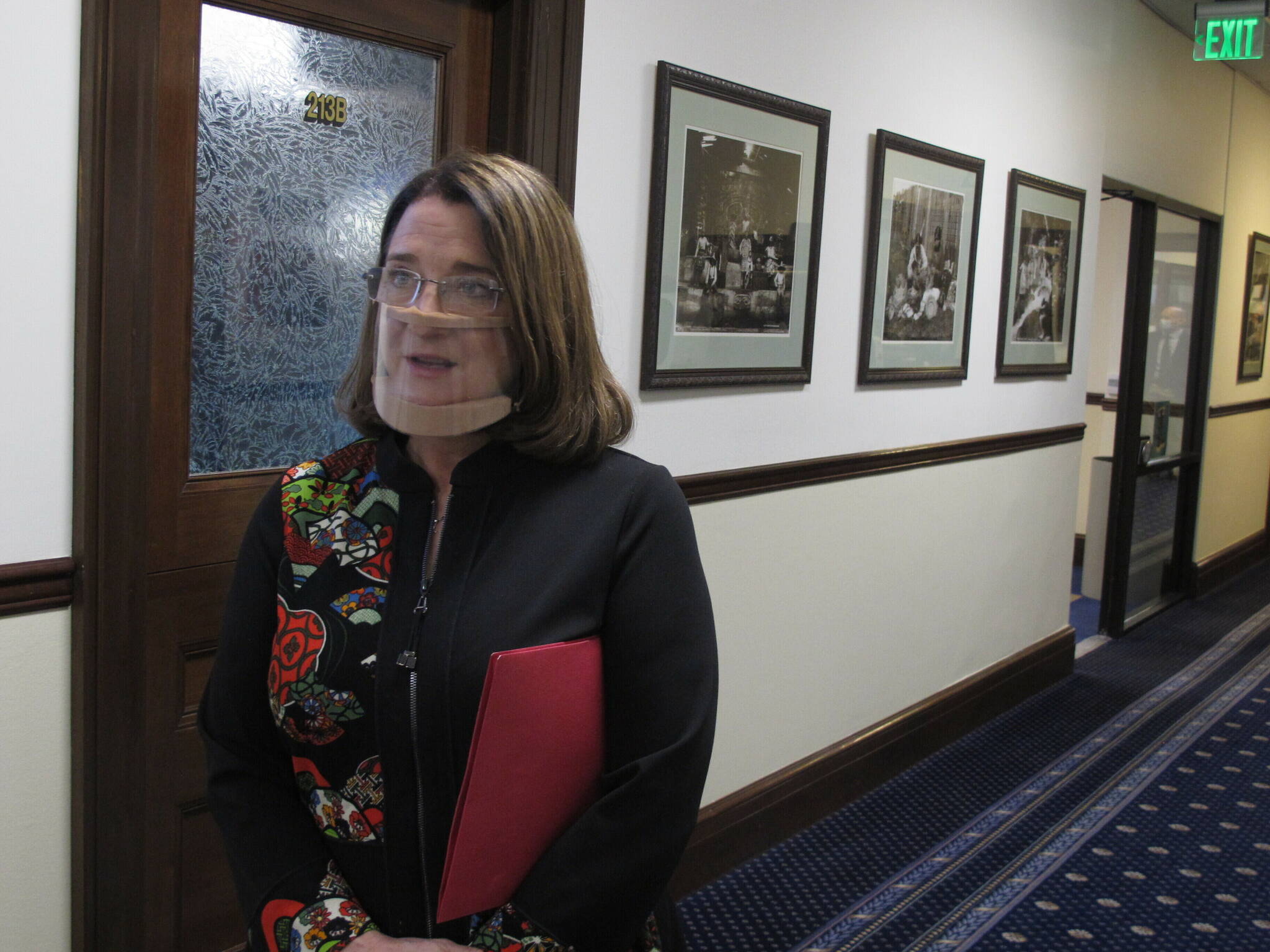 In this March 15, 2021, file photo, Alaska state Sen. Lora Reinbold, an Eagle River Republican, speaks to reporters in Juneau, Alaska. The Alaska state lawmaker has requested an excusal from the state Senate until mid-January, citing the challenges of traveling to Juneau after she was suspended from flying on Alaska Airlines earlier this year. (AP Photo/Becky Bohrer, Pool, File)