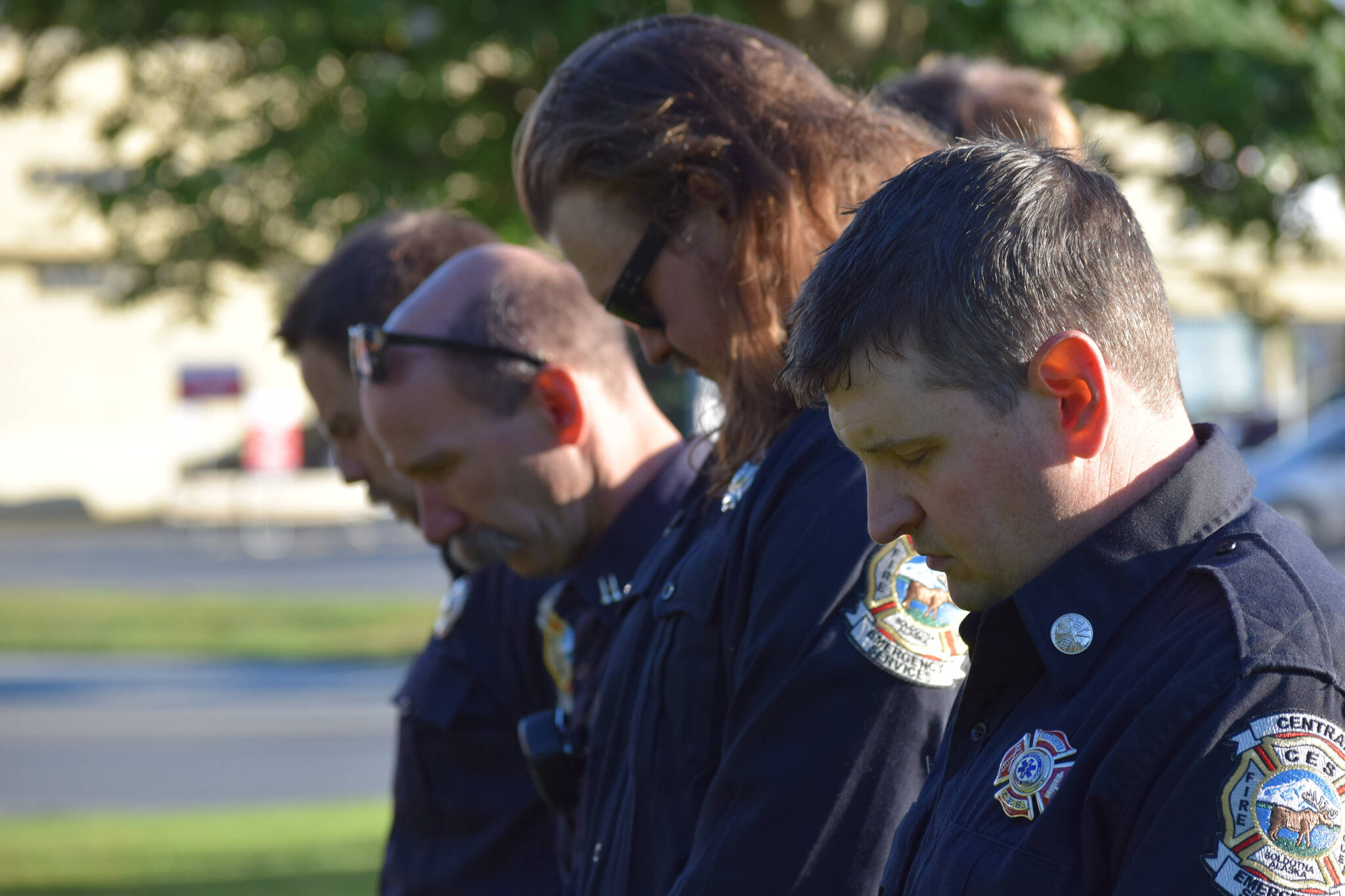 Firefighters bow their heads during the 20th memorial service of the 9/11 terrorist attacks at Central Emergency Services in Soldotna on Saturday, Sept. 11, 2021. (Camille Botello/Peninsula Clarion)