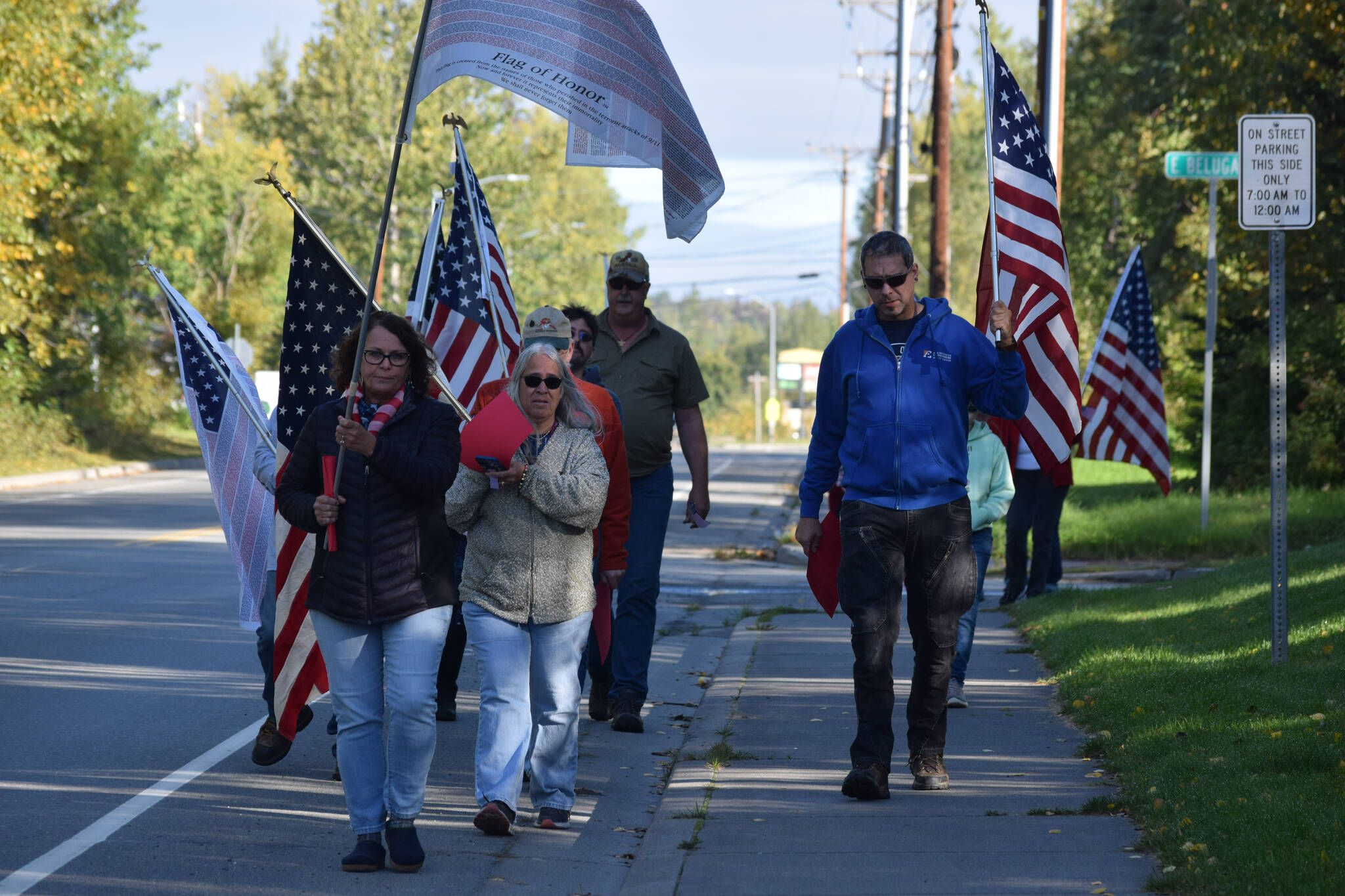 Community members march to Farnsworth Park in Soldotna during the 20th memorial service of the 9/11 terrorist attacks on Saturday, Sept. 11, 2021. (Camille Botello/Peninsula Clarion)