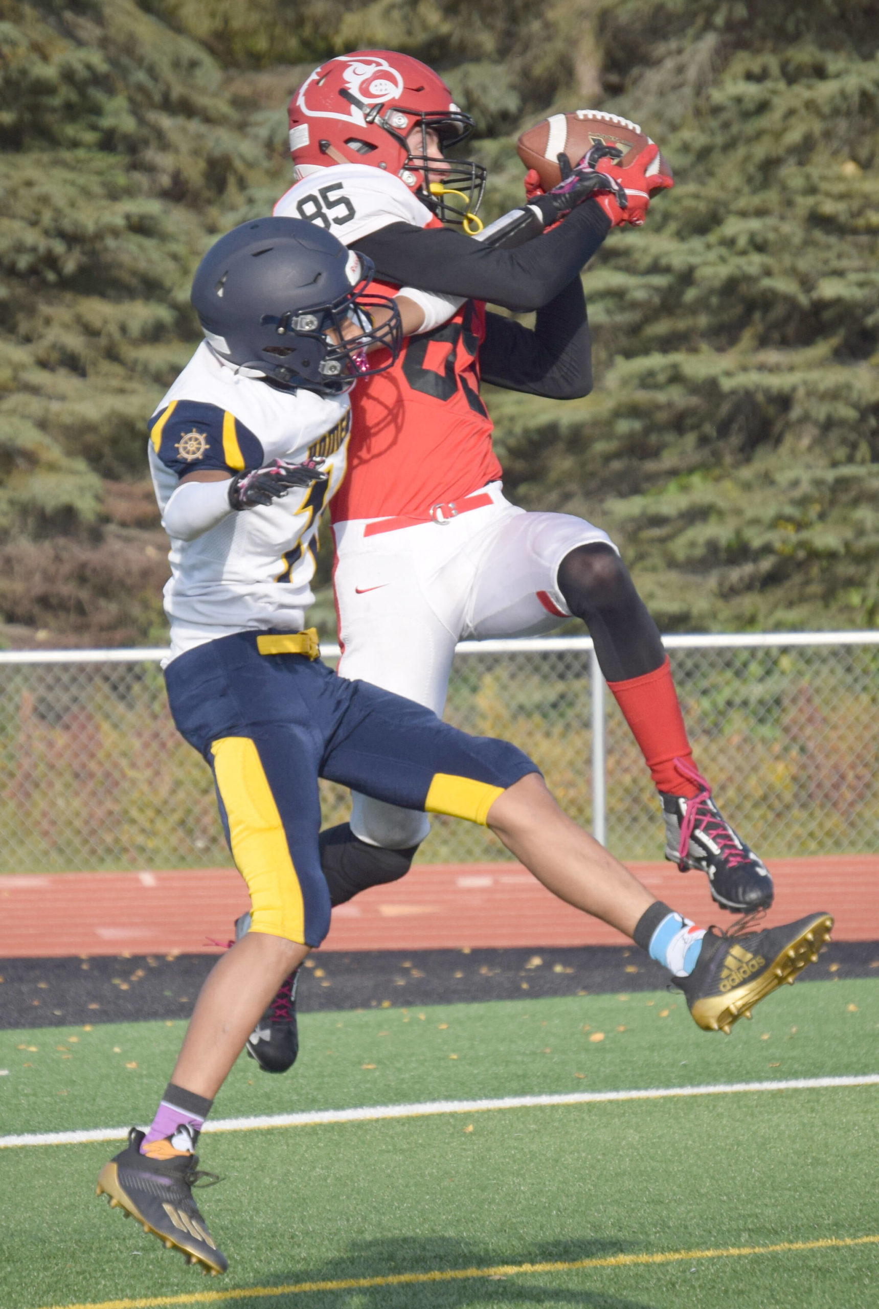 Kenai Central’s David Martin catches a touchdown on Homer’s Morgen Techie on Friday, Sept. 17, 2021, at Ed Hollier Field in Kenai, Alaska. (Photo by Jeff Helminiak/Peninsula Clarion)