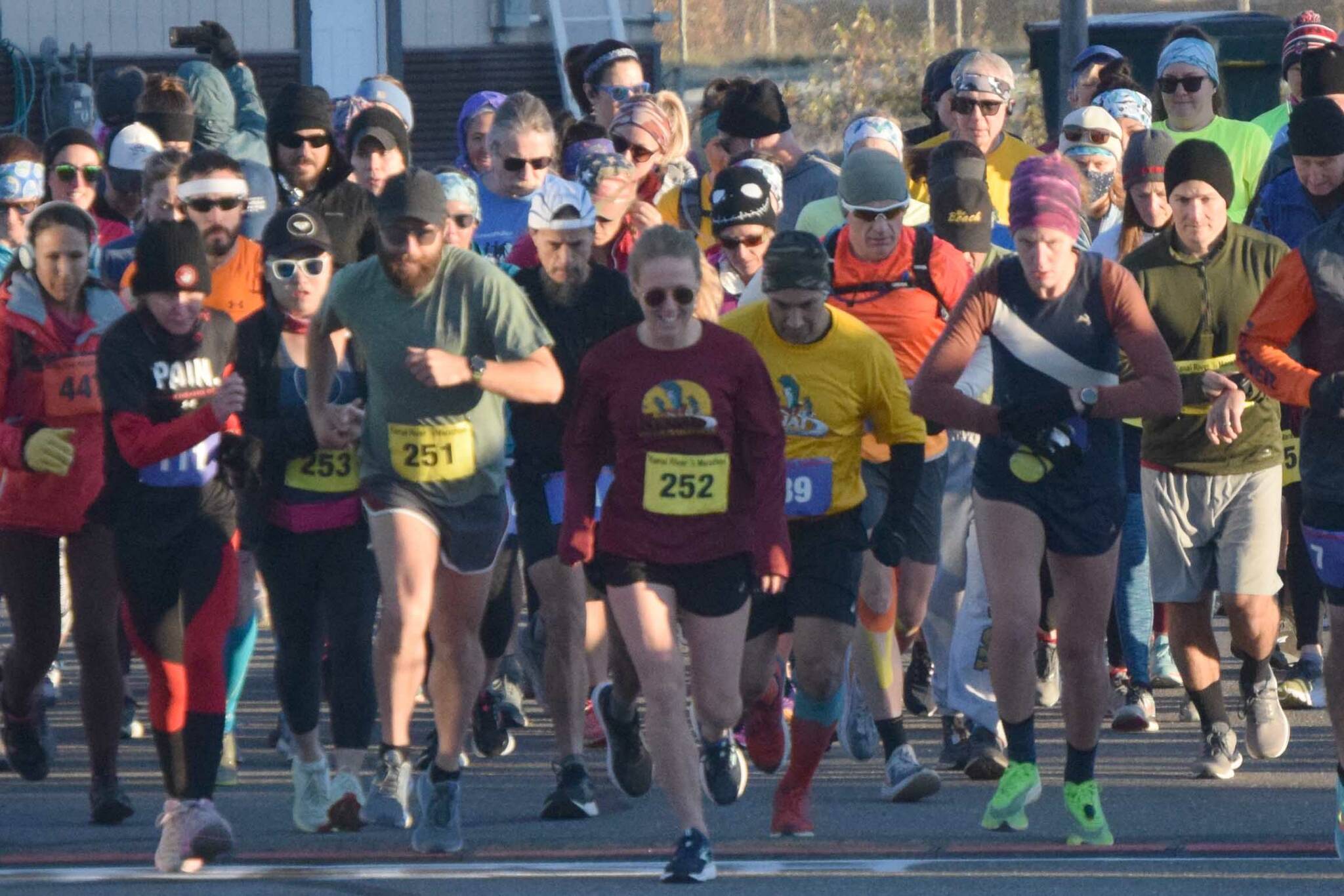 Author Kathleen Sorensen (252) and the rest of the field take off from the starting line at the Kenai River Marathon on Sunday, Sept. 26, 2021, in Kenai, Alaska. (Photo by Jeff Helminiak/Peninsula Clarion)