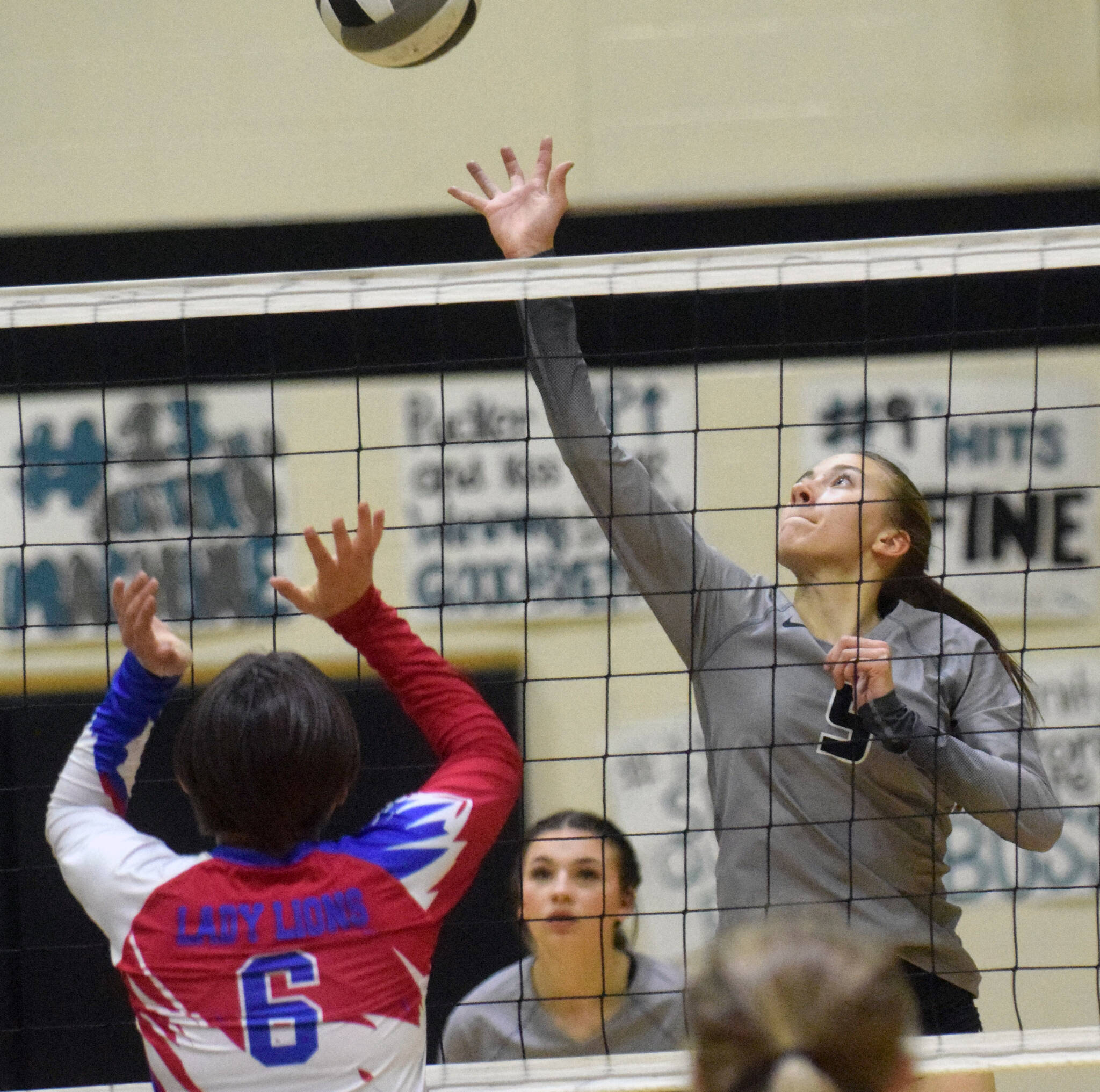 Nikiski’s Rylee Ellis attacks Kelsey Fanning of Anchorage Christian Schools on Friday, Oct. 1, 2021, at Nikiski High School in Nikiski, Alaska. (Photo by Jeff Helminiak/Peninsula Clarion)