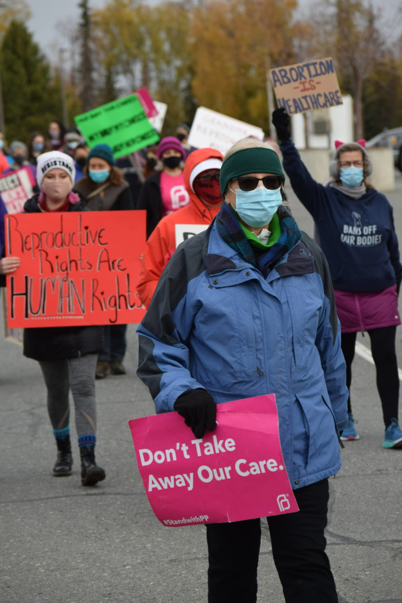 Demonstrators march through Soldotna as part of the national Women’s March “Rally for Abortion Justice” on Saturday, Oct. 2, 2021. (Camille Botello/Peninsula Clarion)
