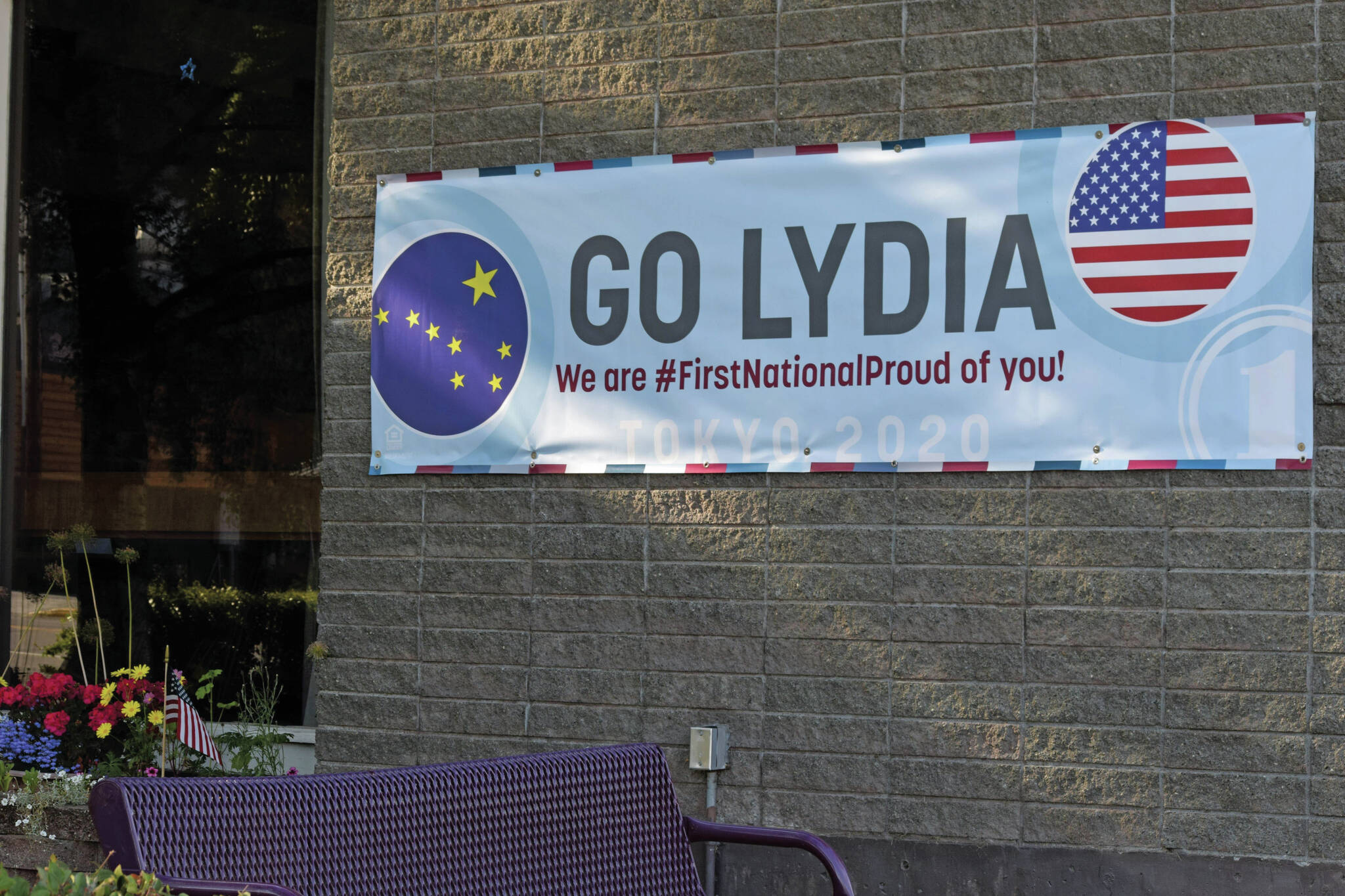 A banner supporting Olympic swimmer Lydia Jacoby hangs outside of First National Bank Alaska in her hometown of Seward on Saturday, July 24, 2021. (Camille Botello / Peninsula Clarion)