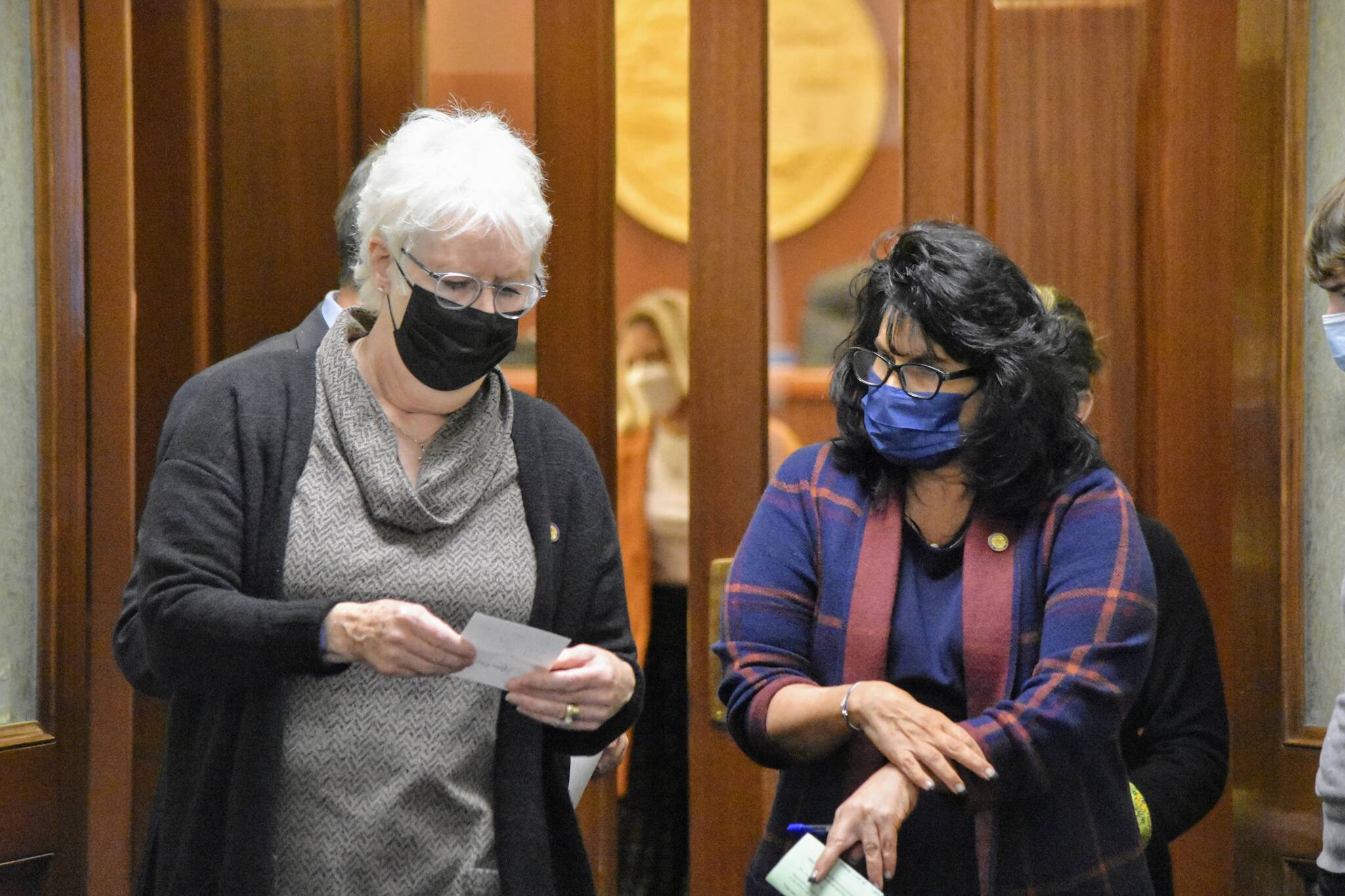 Peter Segall / Juneau Empire
Speaker of the Alaska House of Representatives Louise Stutes, R-Kodiak, and House Minority Leader Cathy Tilton, R-Wasilla, step outside the House chambers on Monday to discuss a message from the Senate. Lawmakers entered their fourth special session Monday, with a resolution to hold committee meetings remotely.