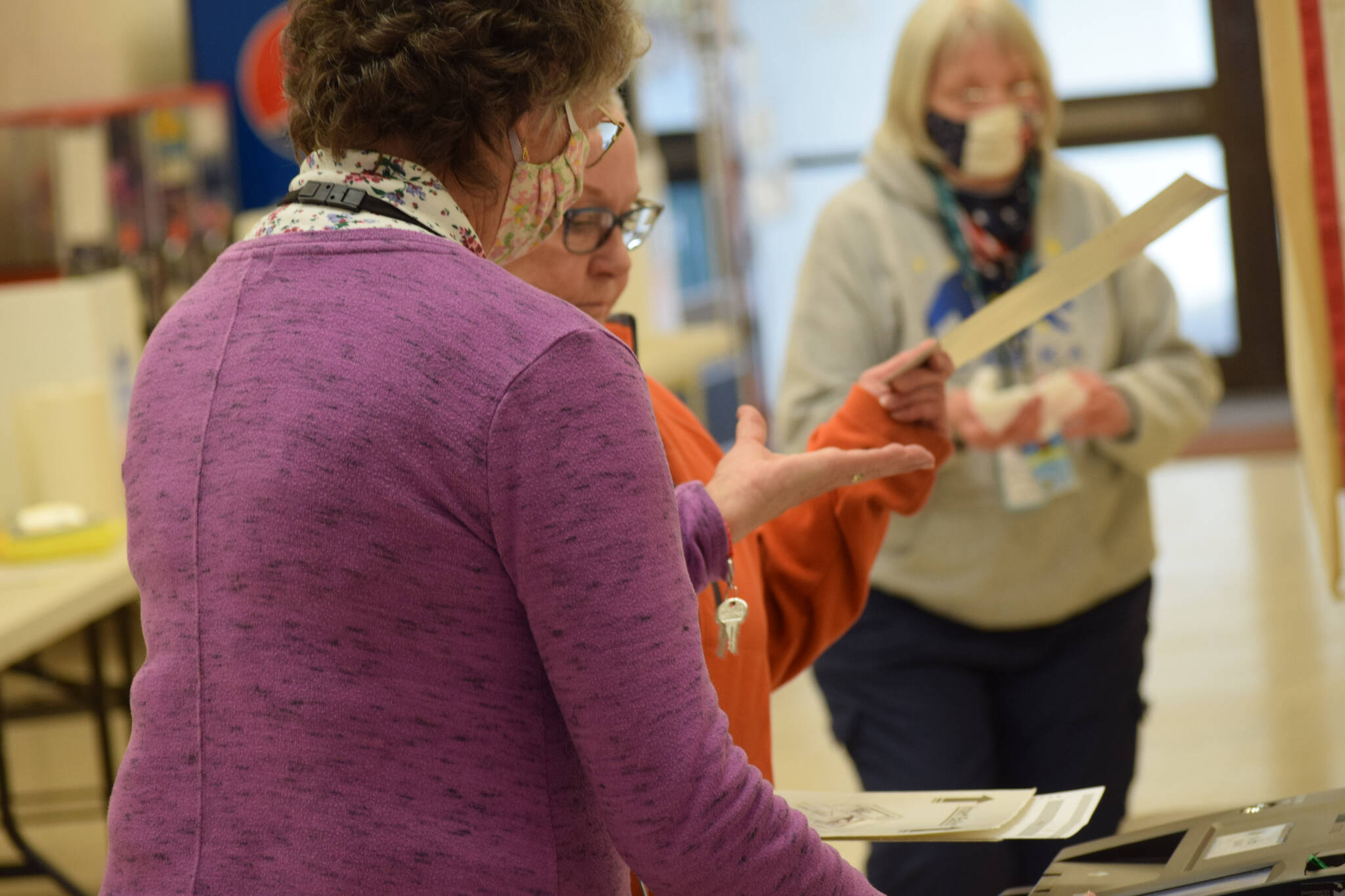 Poll worker Joan Seaman helps Joyce Ellestad cast her vote at Kenai No. 1 precinct on Oct. 5, 2021. (Camille Botello/Peninsula Clarion)