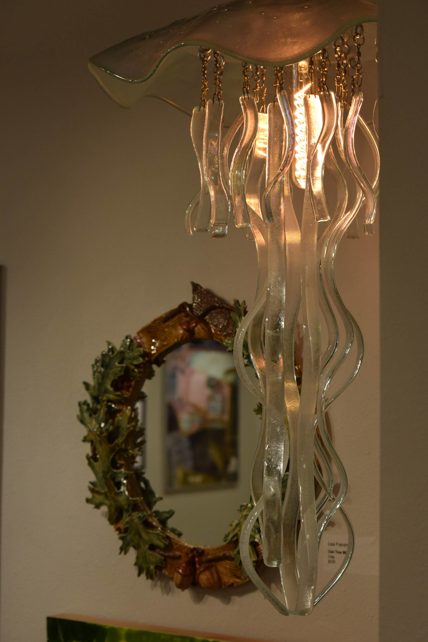 Pieces hang on display at the Kenai Art Center for the open call show on Wednesday, Oct. 6, 2021 in Kenai, Alaska. (Camille Botello/Peninsula Clarion)