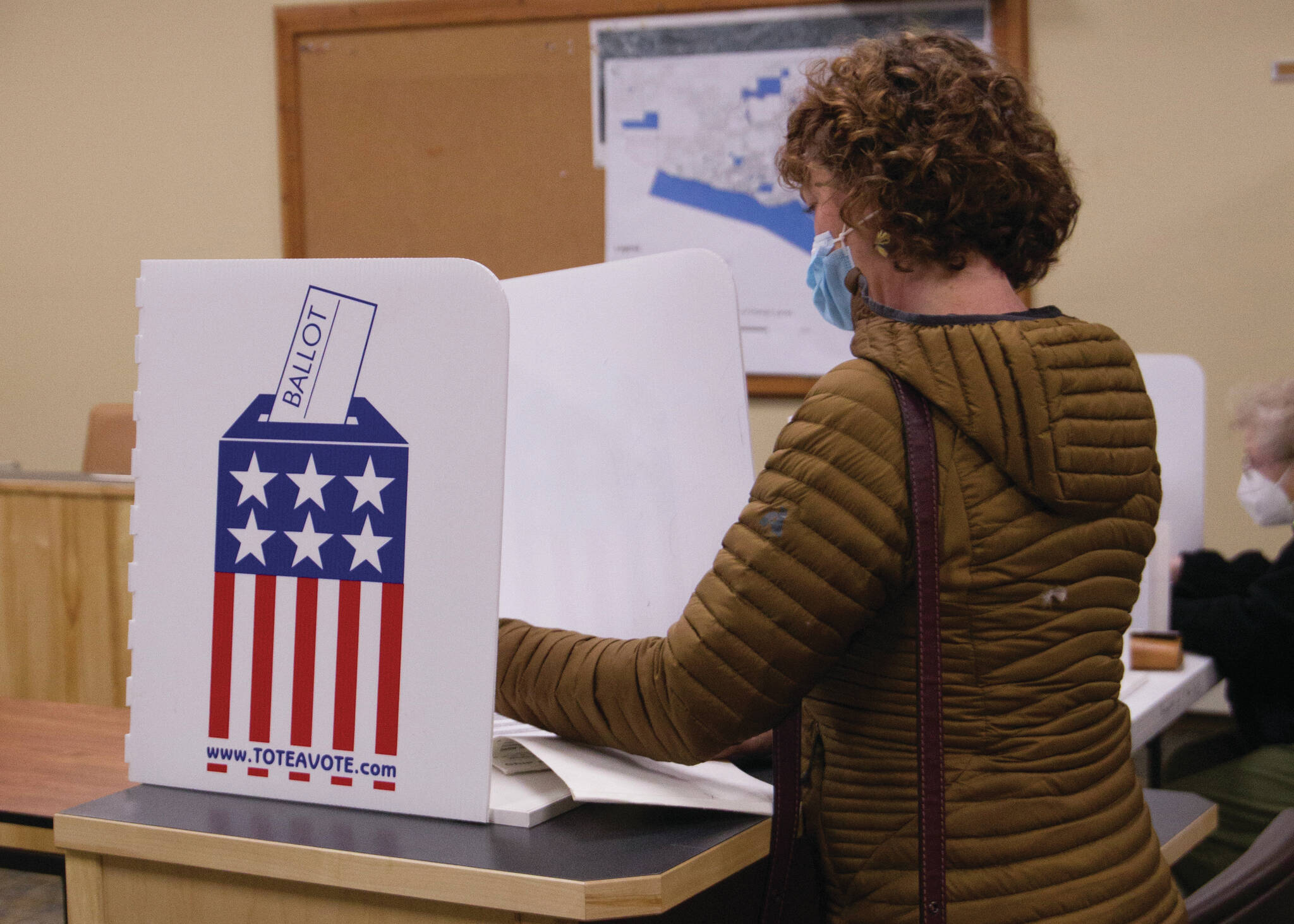 Sarah Knapp / Homer News 
A voter at city hall in Homer reviews their ballot before submitting it on Tuesday