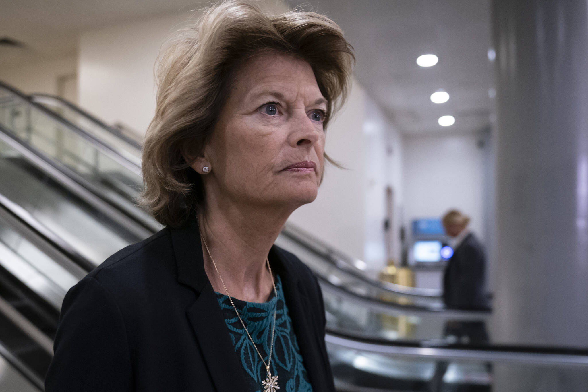 In this Jan. 8, 2020, file photo Sen. Lisa Murkowski, R-Alaska, heads to a briefing on Capitol Hill in Washington. An Alaska man faces federal charges after authorities allege he threatened to hire an assassin to kill Murkowski, according to court documents unsealed Wednesday. (AP Photo/J. Scott Applewhite,File)
