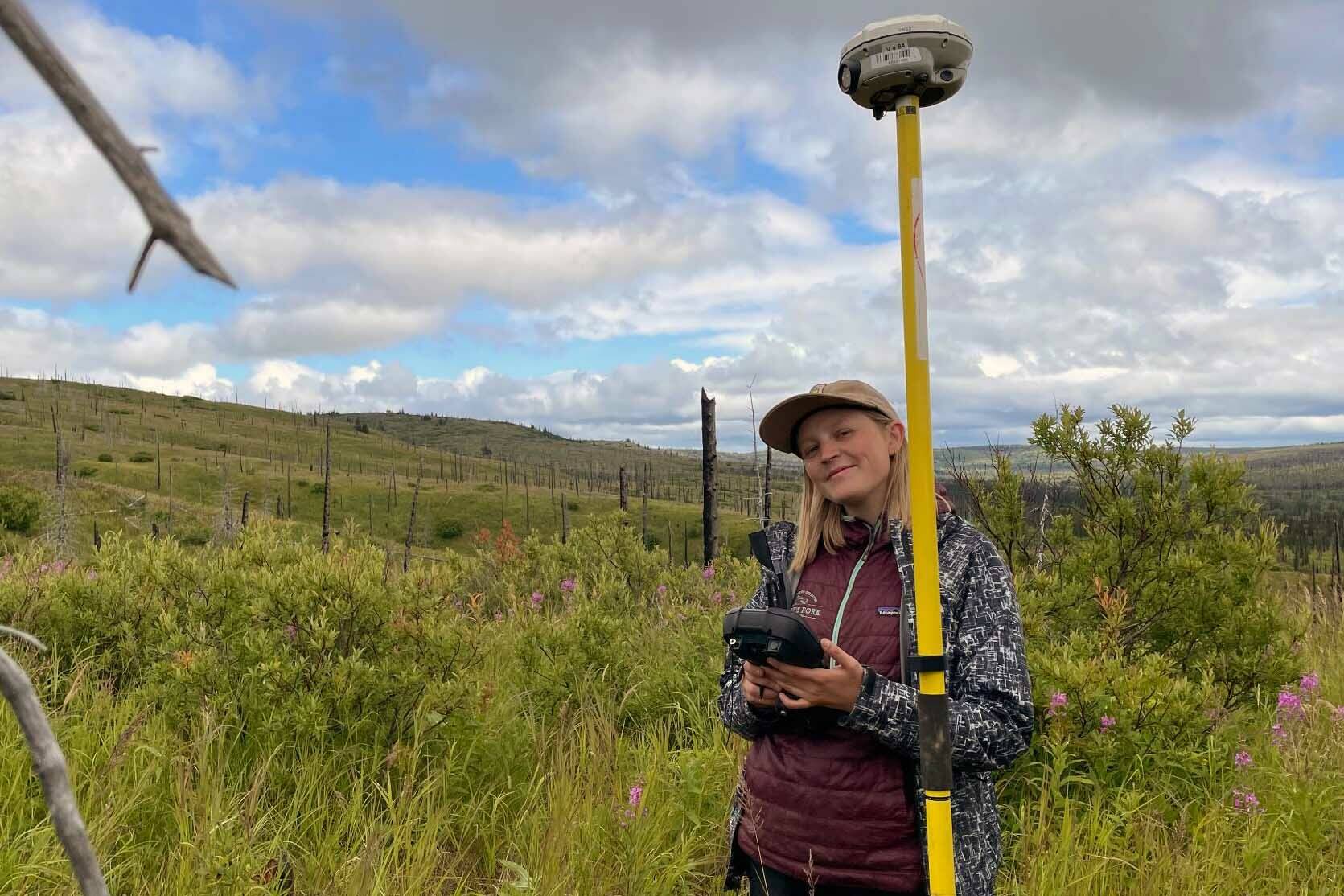 Frannie Nelson collecting ground validation data for her undergraduate thesis in the Caribou Hills. (Photo by Angelica Smith/FWS)
