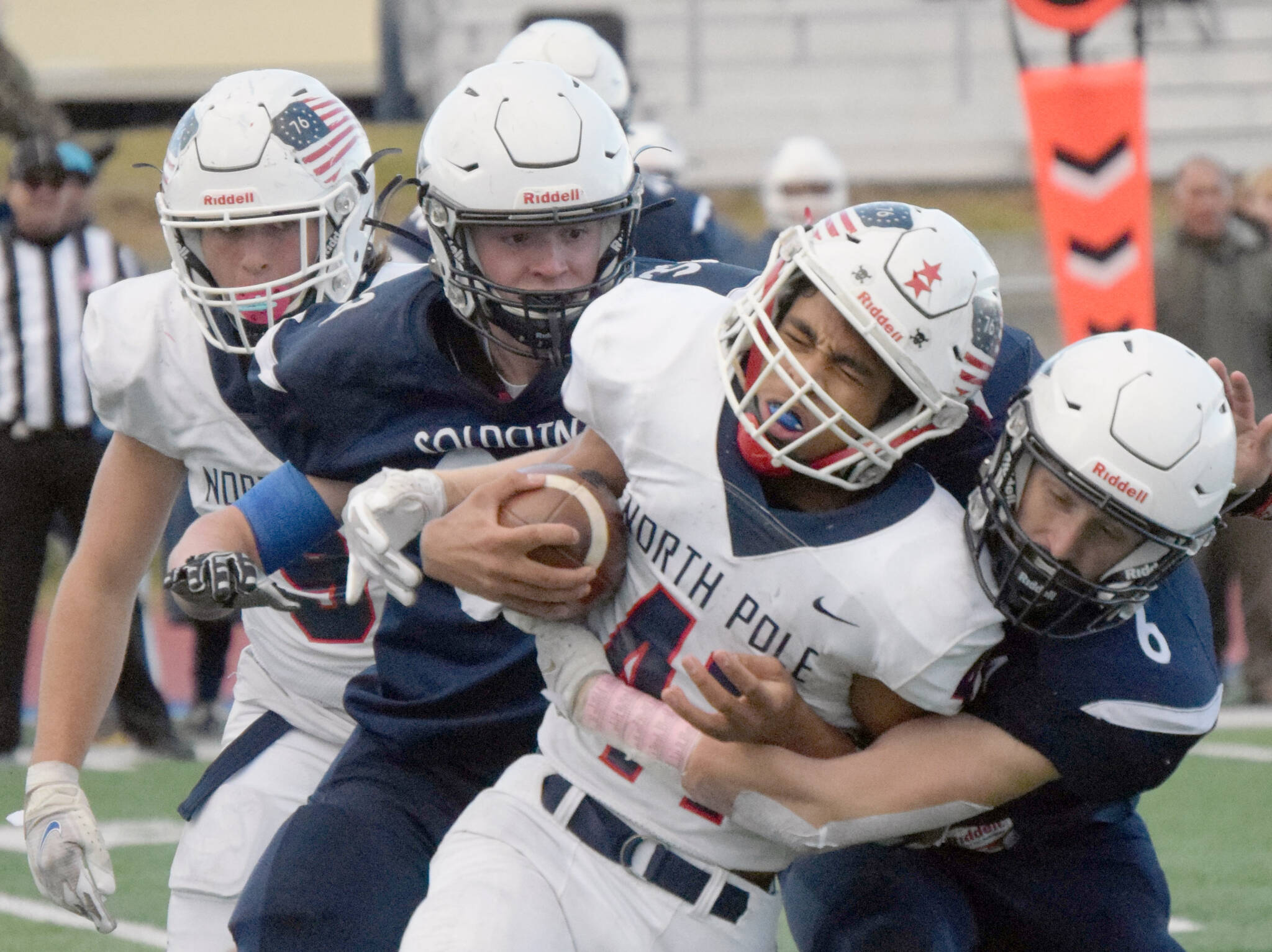 Soldotna’s Jeren Nash and Wayne Mellon combine to bring down Via Skipps of North Pole on Friday, Oct. 8, 2021, at Justin Maile Field in Soldotna, Alaska. (Photo by Jeff Helminiak/Peninsula Clarion)
