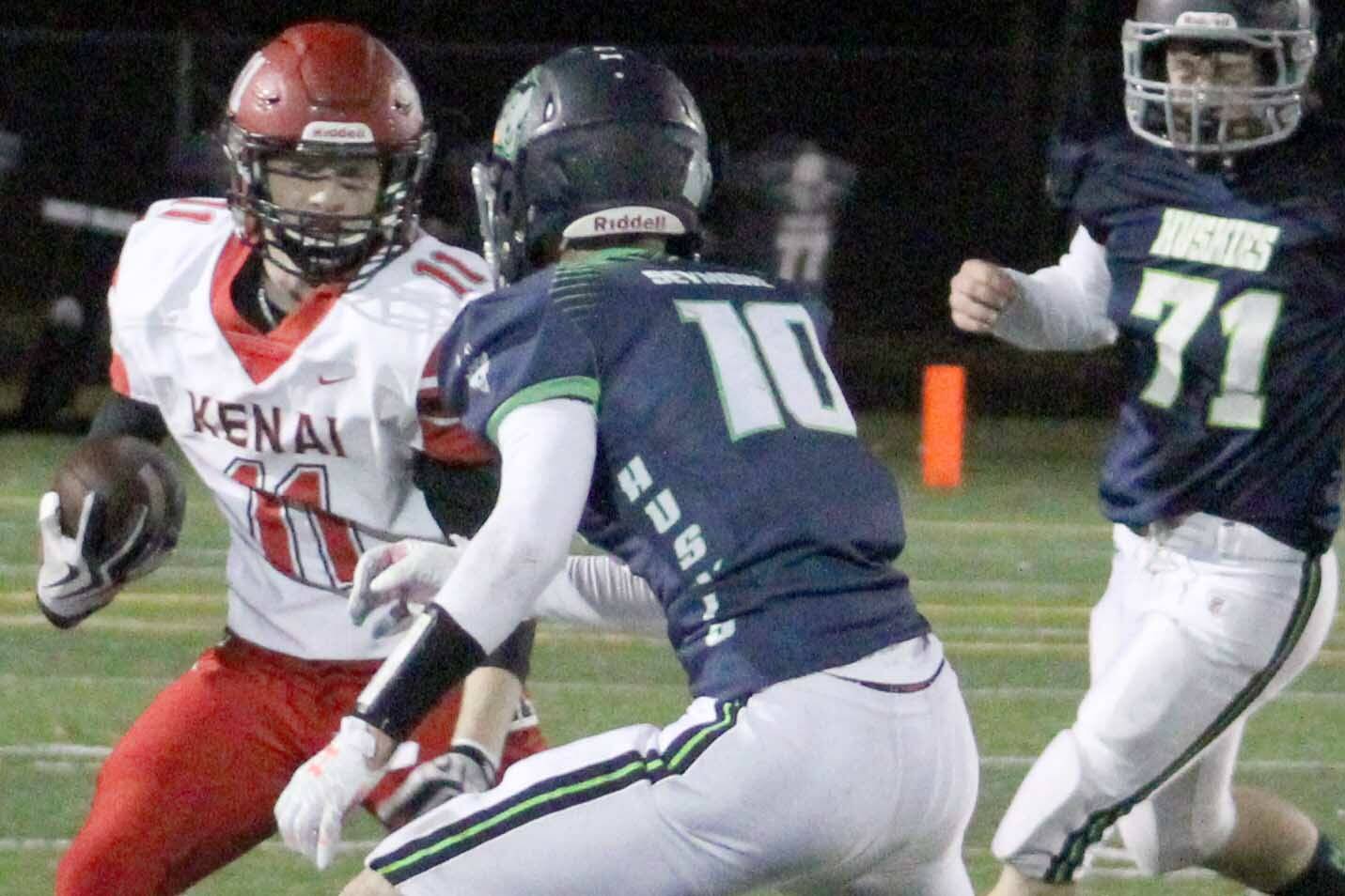 Kenai Central's Wade James rushes the ball against Redington on Friday, Oct. 8, 2021, at Redington High School. (Photo by Tim Rockey/Frontiersman)