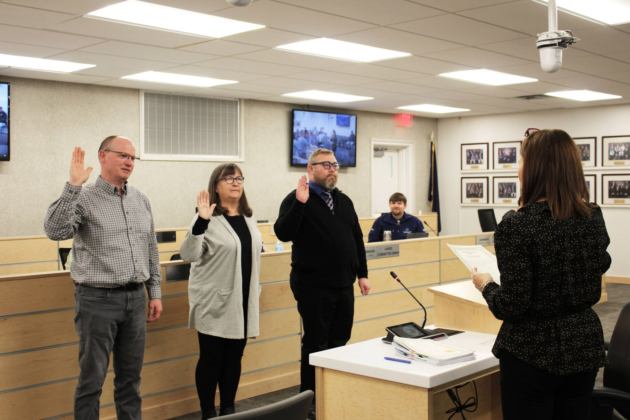 Kenai Peninsula Borough Clerk Johni Blankenship (right) swears in new members of the Kenai Peninsula Borough Assembly Brent Hibbert (left), Cindy Ecklund (second from left) and Mike Tupper during a meeting of the Kenai Peninsula Borough Assembly on Tuesday, Oct. 12, 2021 in Soldotna, Alaska. (Ashlyn OHara/Peninsula Clarion)