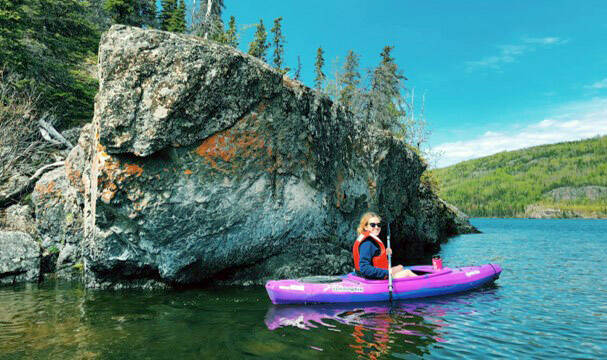 MJ Hendren pictured kayaking at Hidden Lake next to a large rock exposure. (Photo provided)