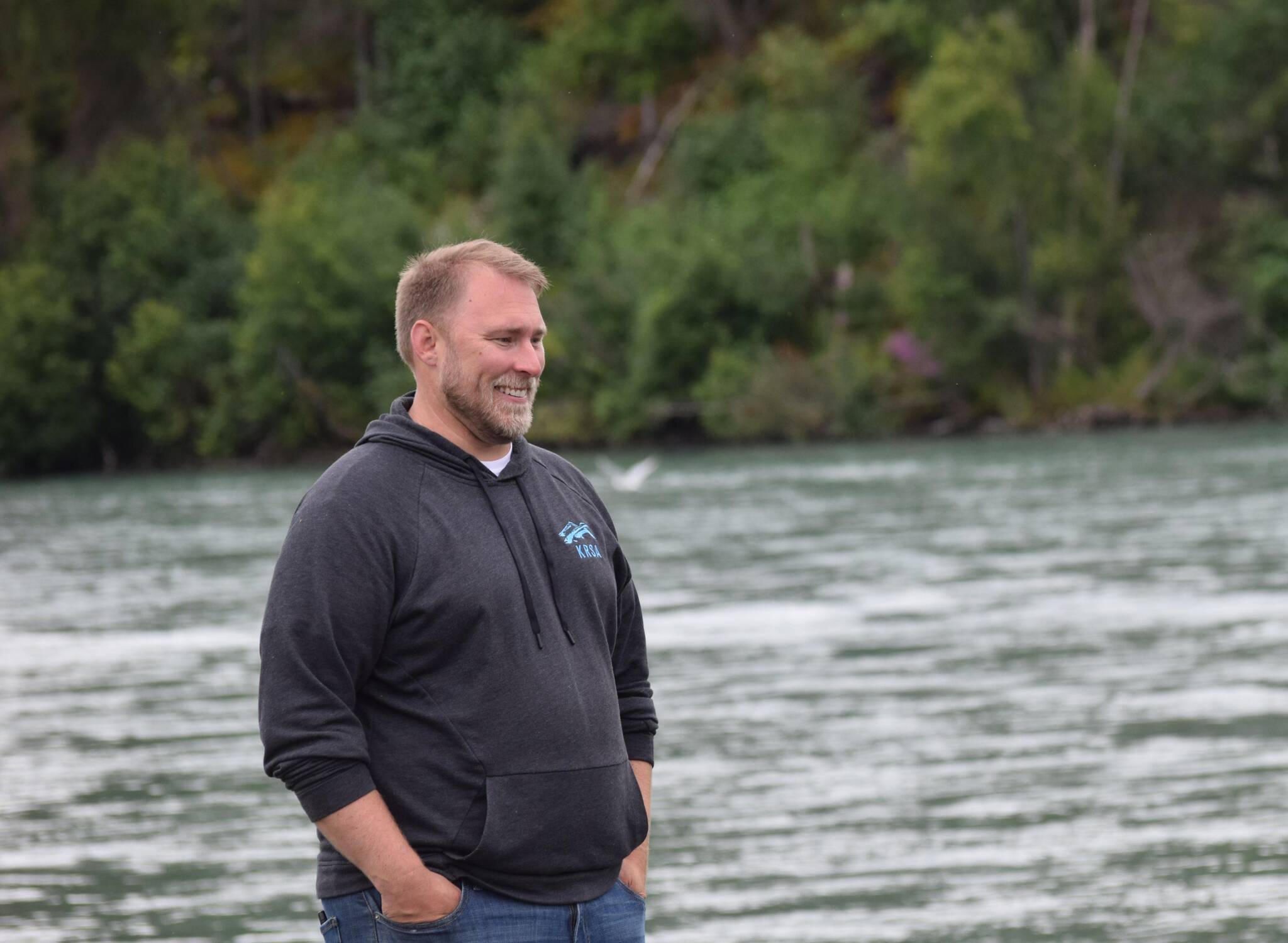 Ben Mohr watches Kenai River Junior Classic participants head out to fish on the Kenai River in Soldotna, Alaska, on Wednesday, Aug. 11, 2021. (Camille Botello / Peninsula Clarion)