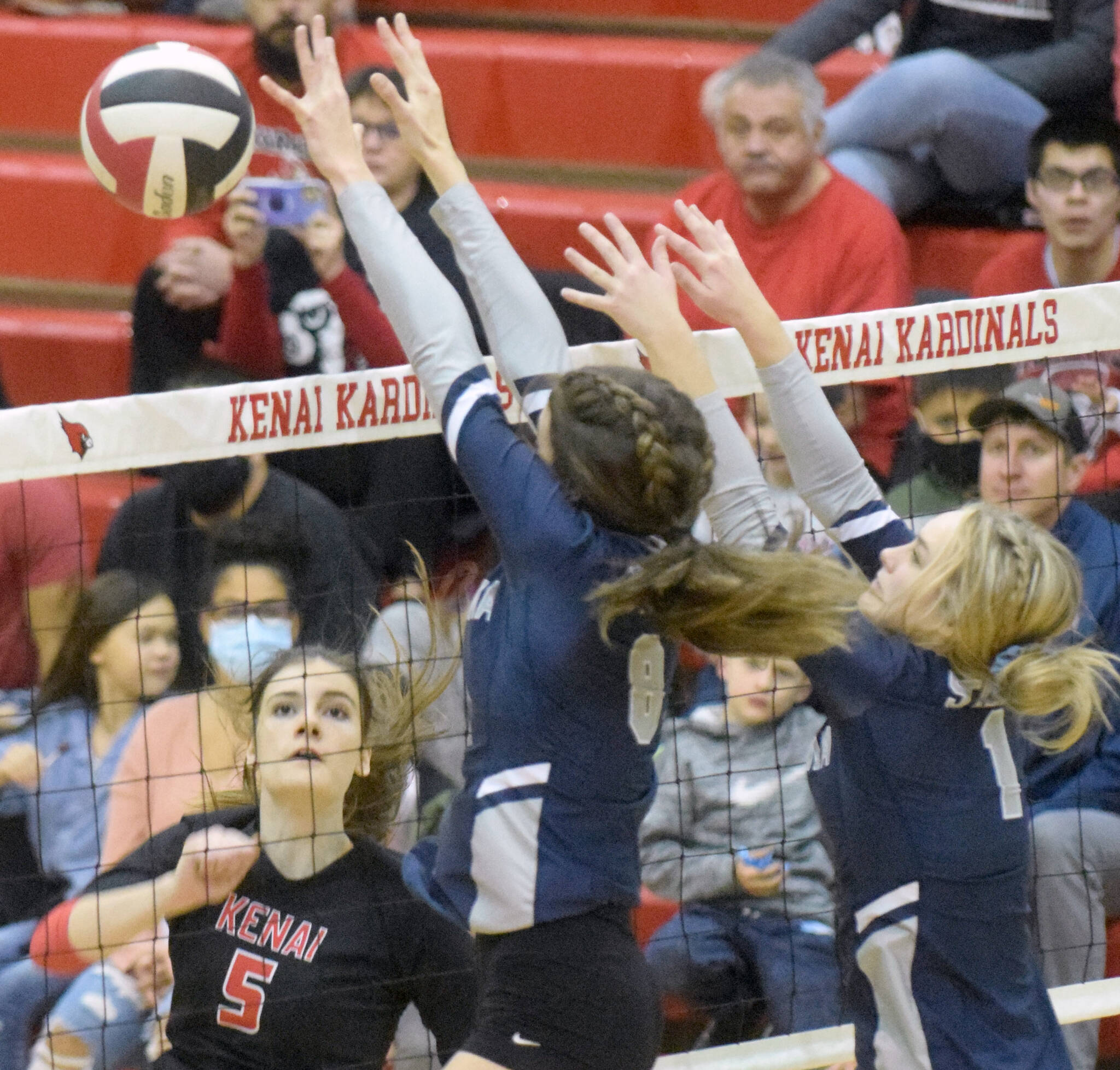 Kenai Centrals Brooke Ashley attacks Soldotnas Adarra Hagelund and Jolie Widaman on Tuesday, Oct. 26, 2021, at Kenai Central High School in Kenai, Alaska. (Photo by Jeff Helminiak/Peninsula Clarion)