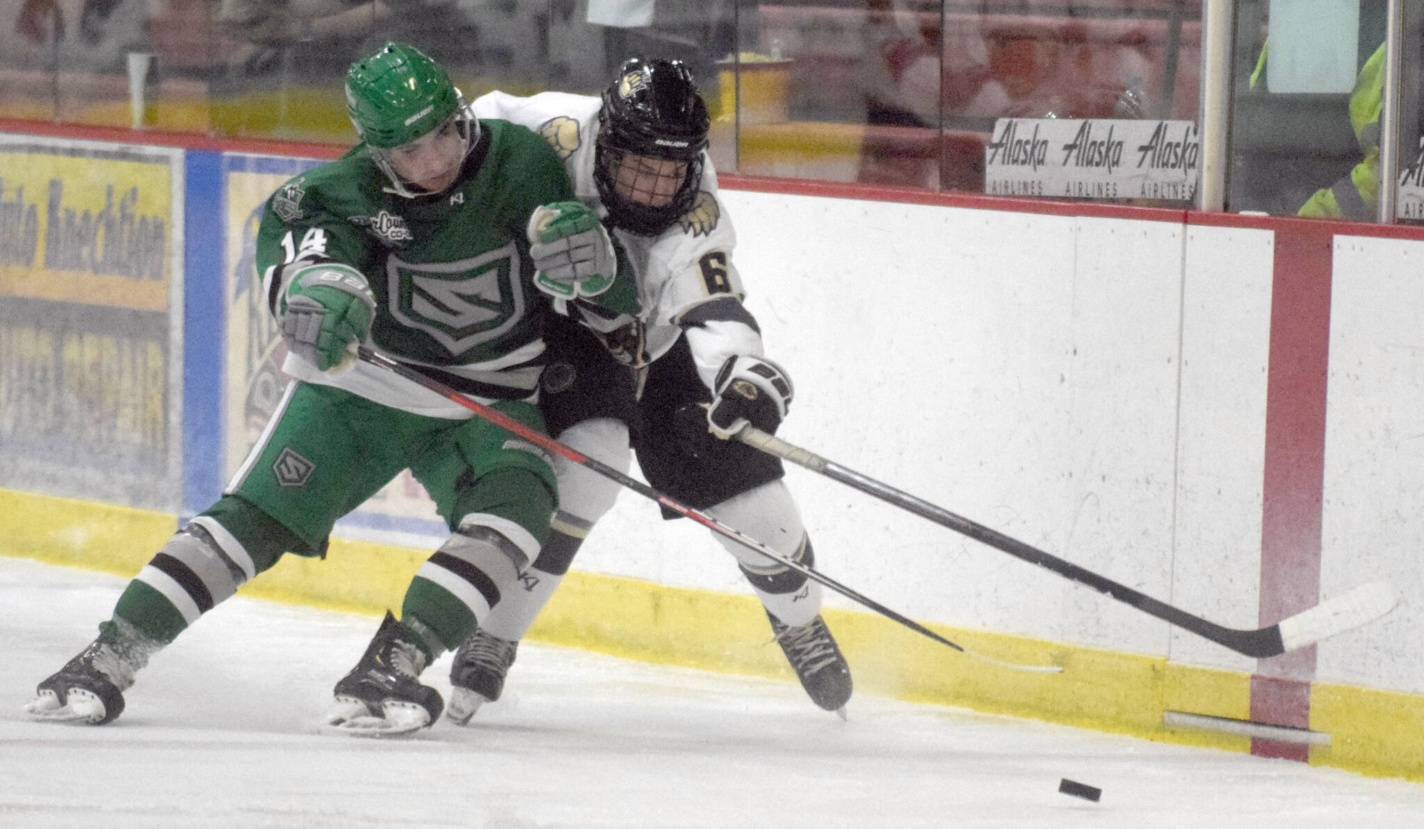 Jax Schauer of the Chippewa (Wisconsin) Steel and Dylan Evans of the Kenai River Brown Bears battle for the puck Friday, Oct. 21, 2021, at the Soldotna Regional Sports Complex in Soldotna, Alaska. (Photo by Jeff Helminiak/Peninsula Clarion)