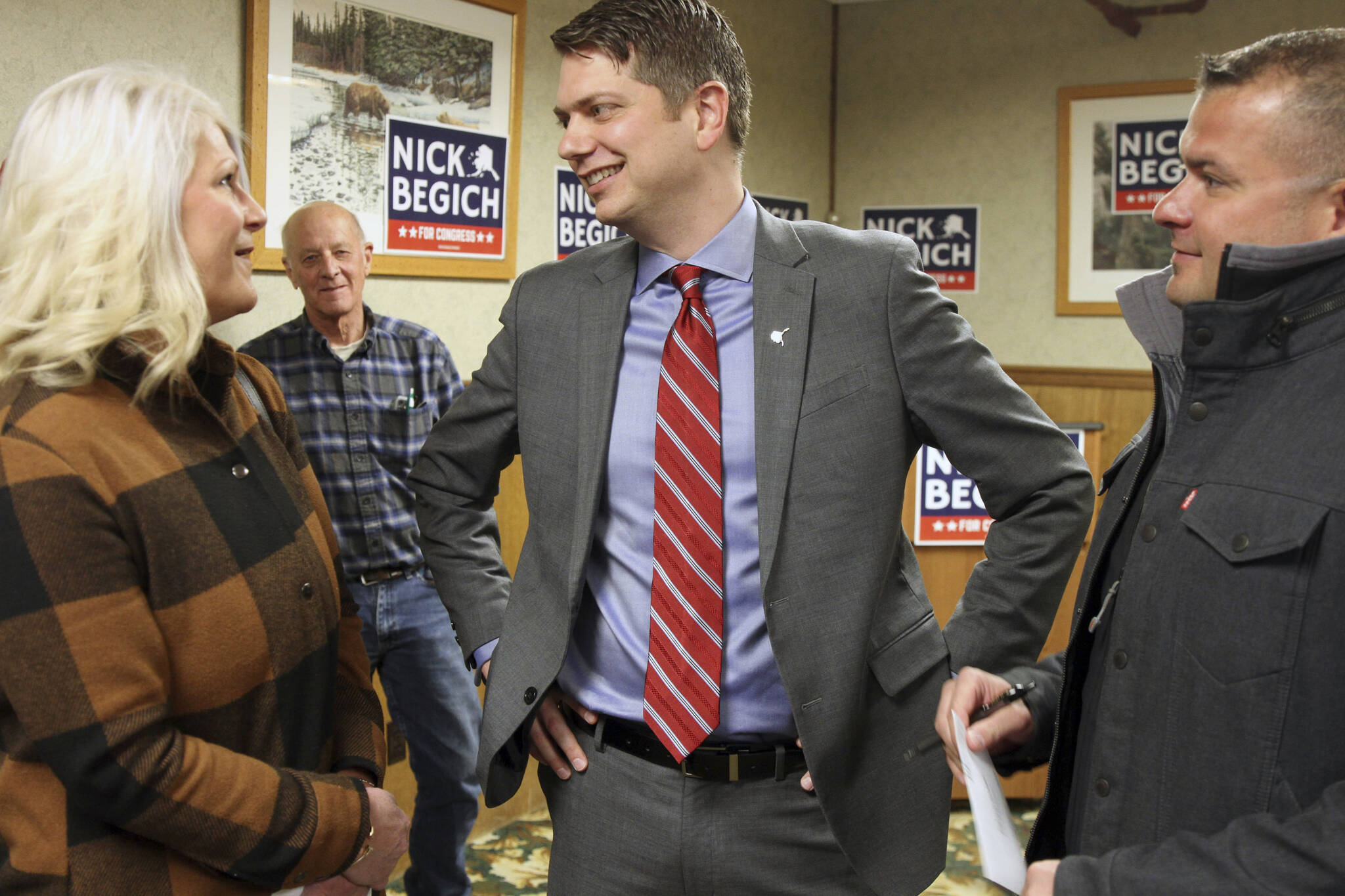 Nicholas Begich III, middle, speaks with supporters ahead of announcing his plans to run for Alaska’s lone U.S. House seat on Thursday, Oct. 28, 2021, in Wasilla, Alaska. Begich, a Republican, plans to run for the seat that has been held since 1973 by Republican Rep. Don Young. (AP Photo/Mark Thiessen)