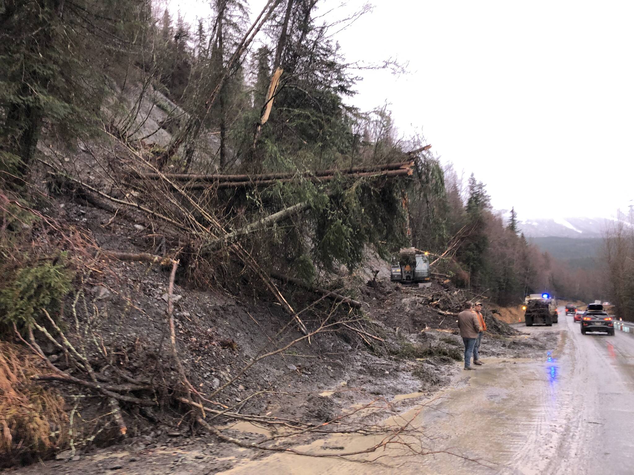 Debris is cleared on a section of the Sterling Highway on Monday, Nov. 1, 2021 near Cooper Landing, Alaska. A landslide on Sunday morning blocked both lanes of the highway, which had partially reopened Monday. (Camille Botello/Peninsula Clarion)