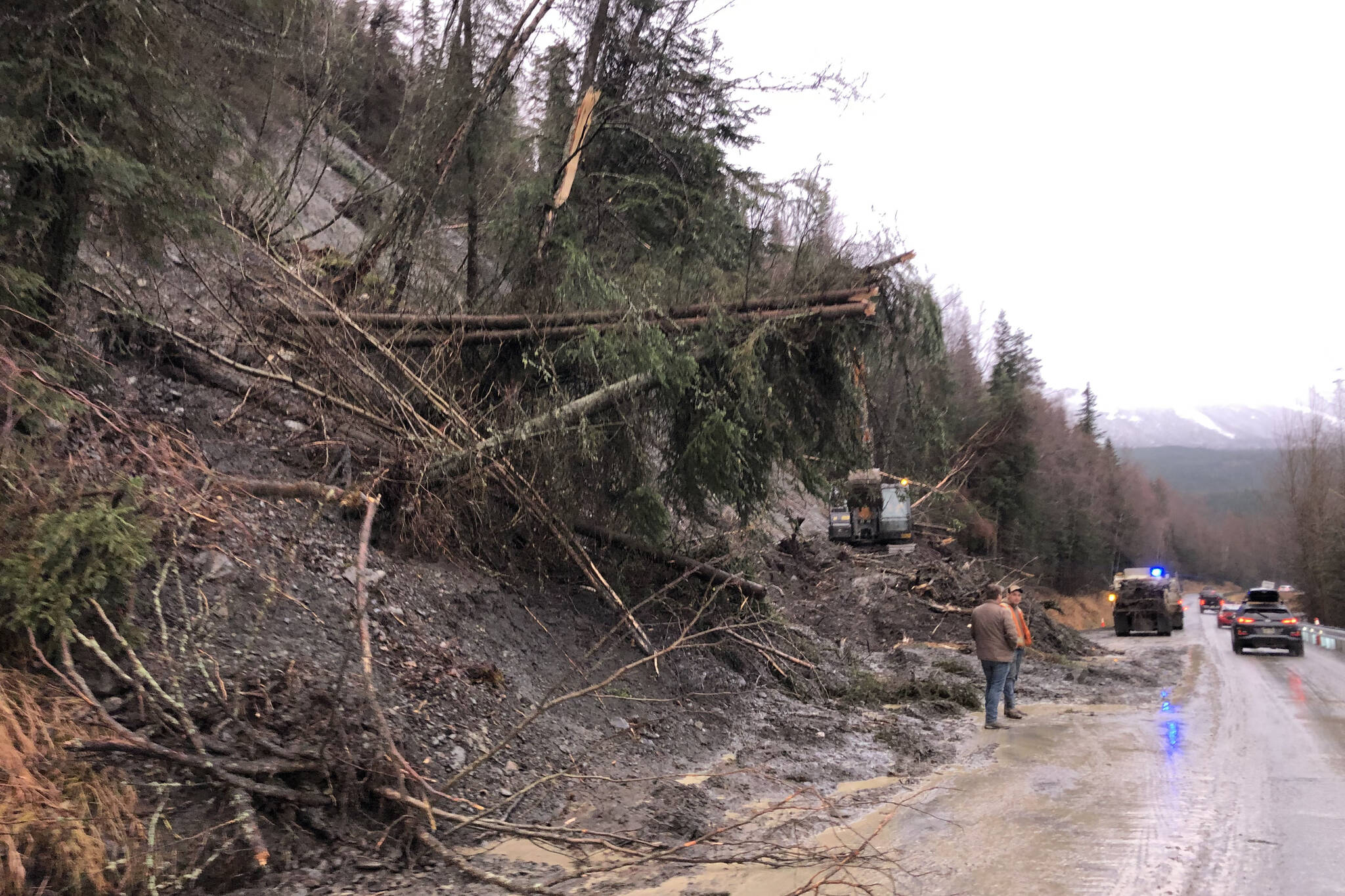 Debris is cleared on a section of the Sterling Highway on Monday, Nov. 1, 2021 near Cooper Landing, Alaska. A landslide on Sunday morning blocked both lanes of the highway, which had partially reopened Monday. (Camille Botello/Peninsula Clarion)