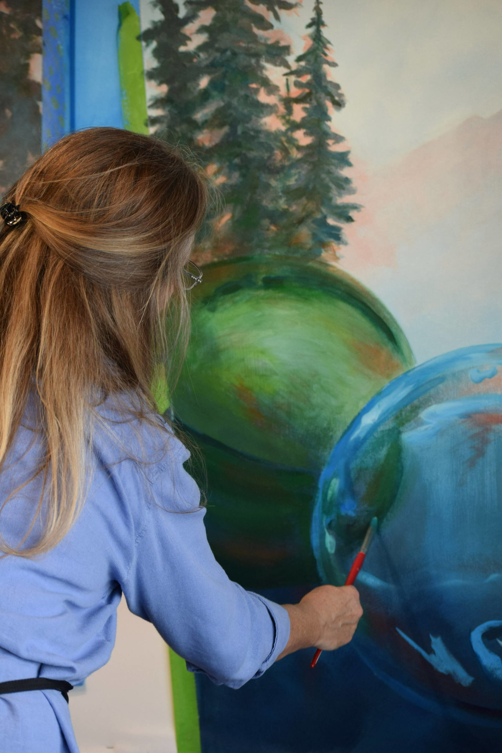Melinda Hershberger works on her installation for the Kenai Art Center’s collaborative mural project on Wednesday, Nov. 3, 2021. (Camille Botello/Peninsula Clarion)