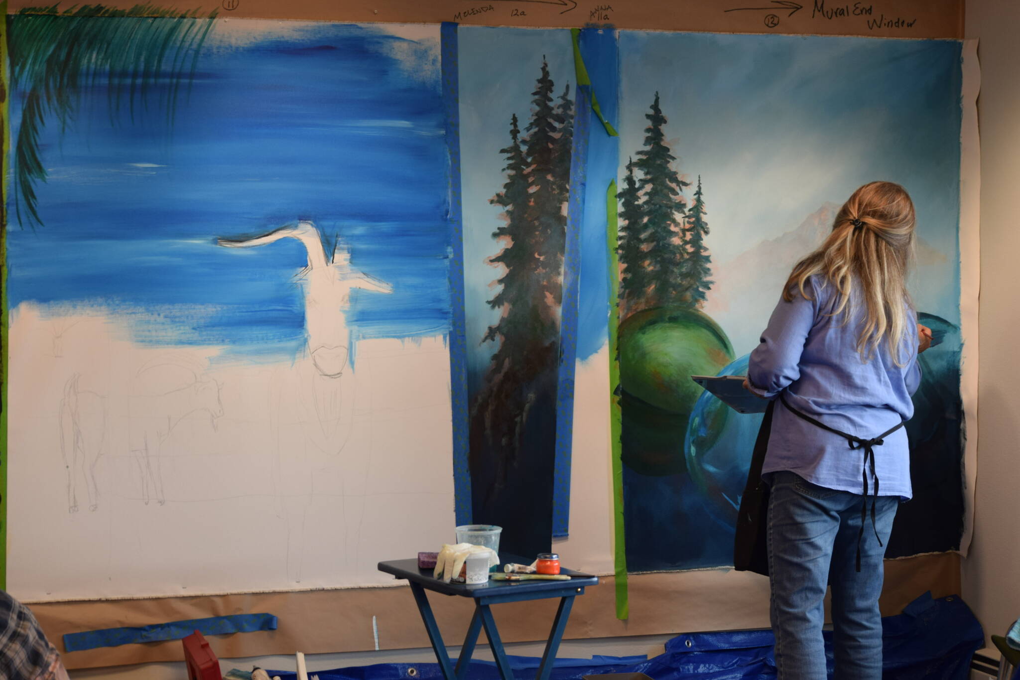 Melinda Hershberger works on her installation for the Kenai Art Center’s collaborative mural project on Wednesday, Nov. 3, 2021. (Camille Botello/Peninsula Clarion)