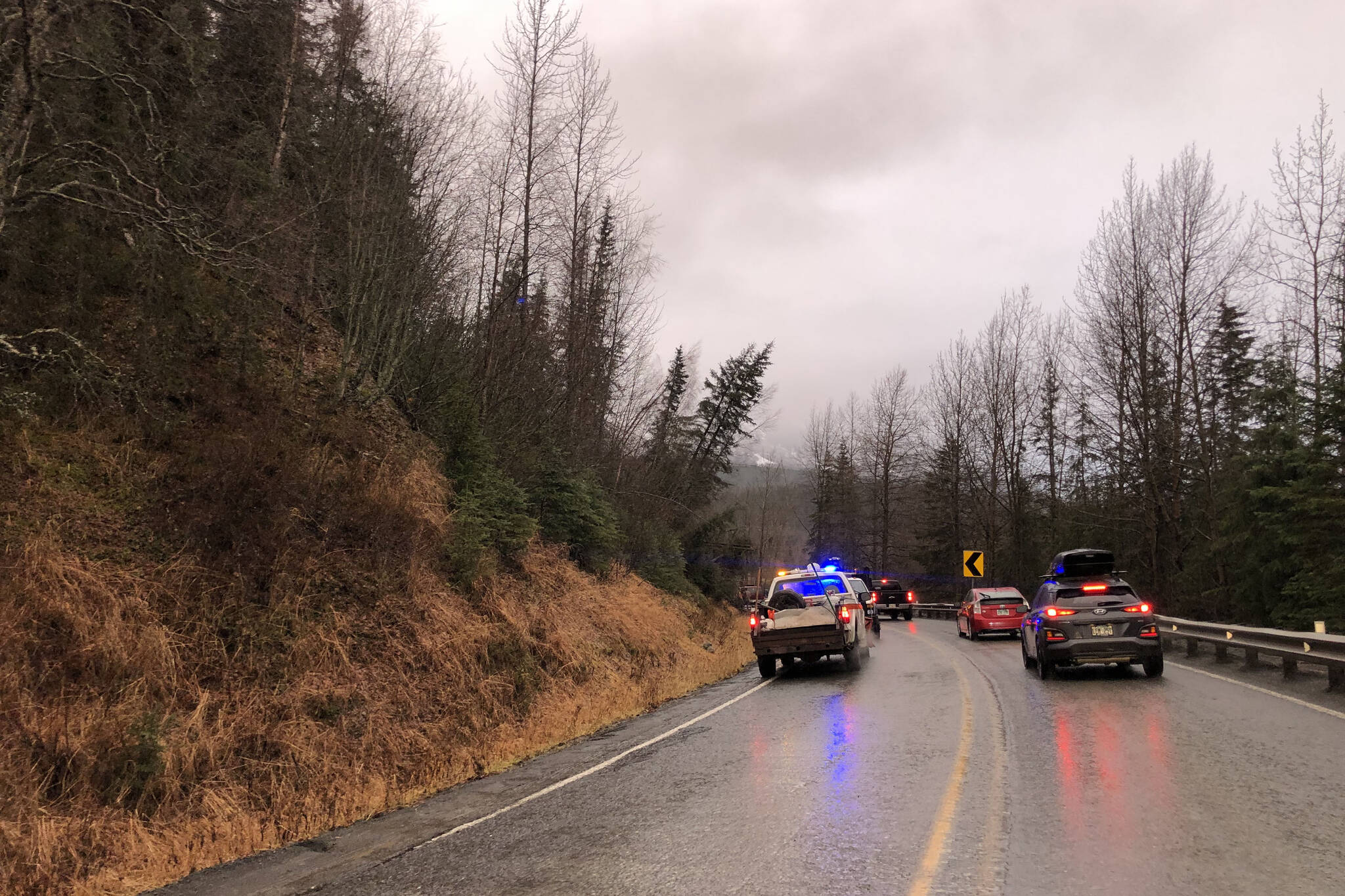 Cars wait on Monday, Nov. 1, 2021 while debris is cleared on a section of the Sterling Highway that was blocked by a landslide that took place on Sunday, Oct. 31, 2021, near Cooper Landing, Alaska. (Camille Botello/Peninsula Clarion)