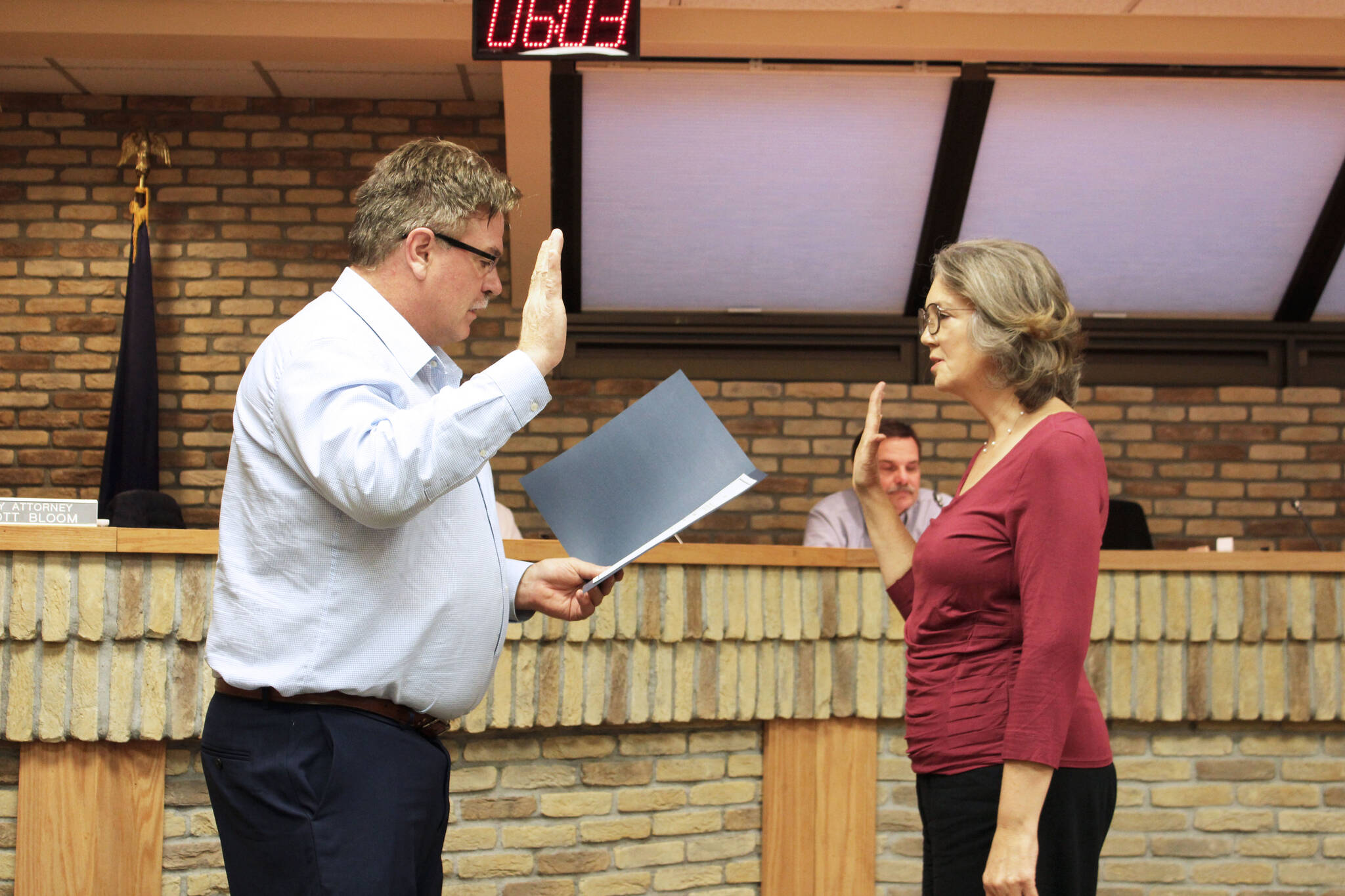 Kenai Mayor Brian Gabriel (left) swears in Kenai City Council member Deborah Sounart during a meeting of the Kenai City Council on Wednedsay, Nov. 3, 2021 in Kenai, Alaska. (Ashlyn O’Hara/Peninsula Clarion)