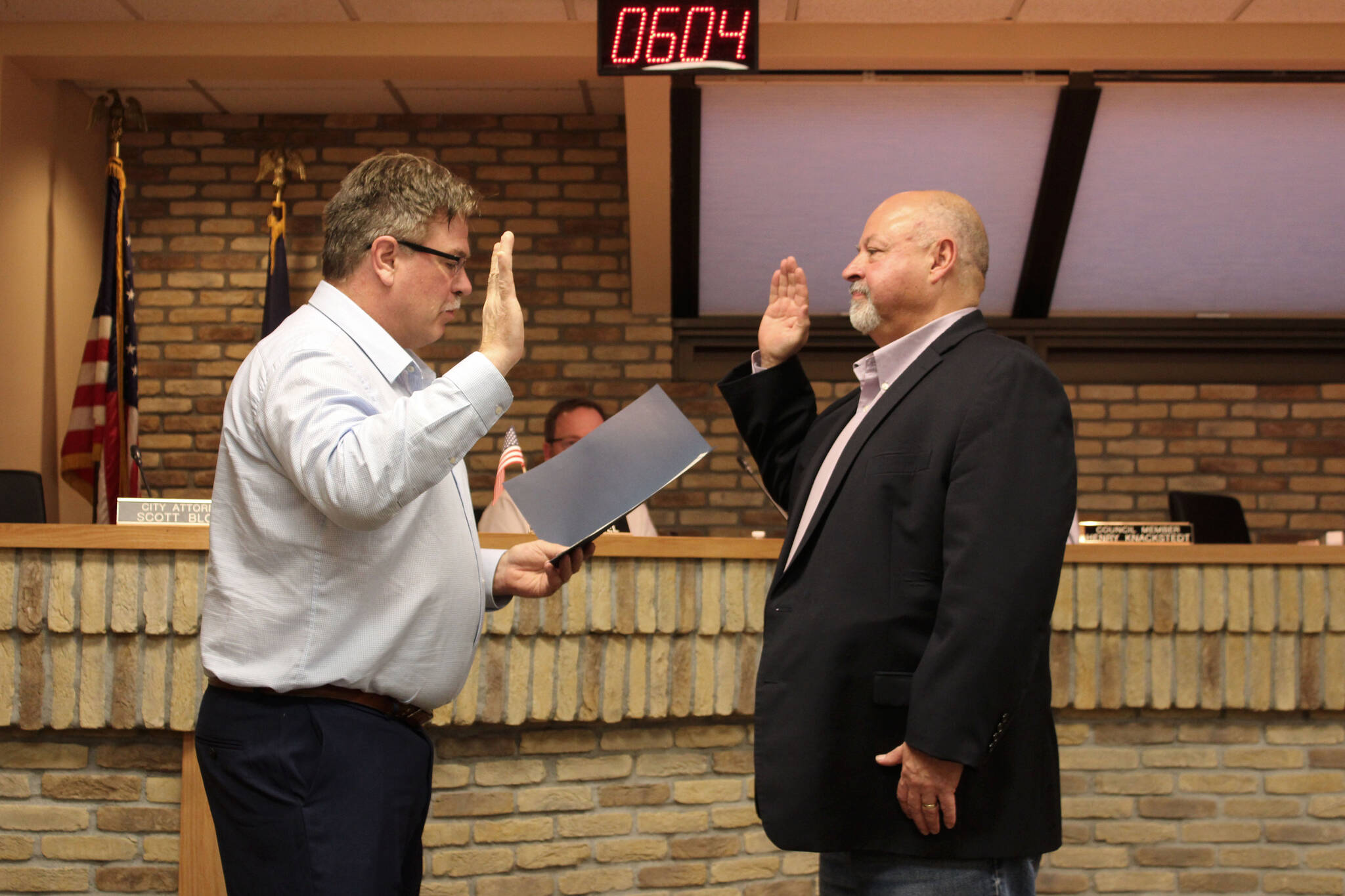 Kenai Mayor Brian Gabriel (left) swears in Kenai City Council member James Baisden during a meeting of the Kenai City Council on Wednedsay, Nov. 3, 2021 in Kenai, Alaska. (Ashlyn O’Hara/Peninsula Clarion)