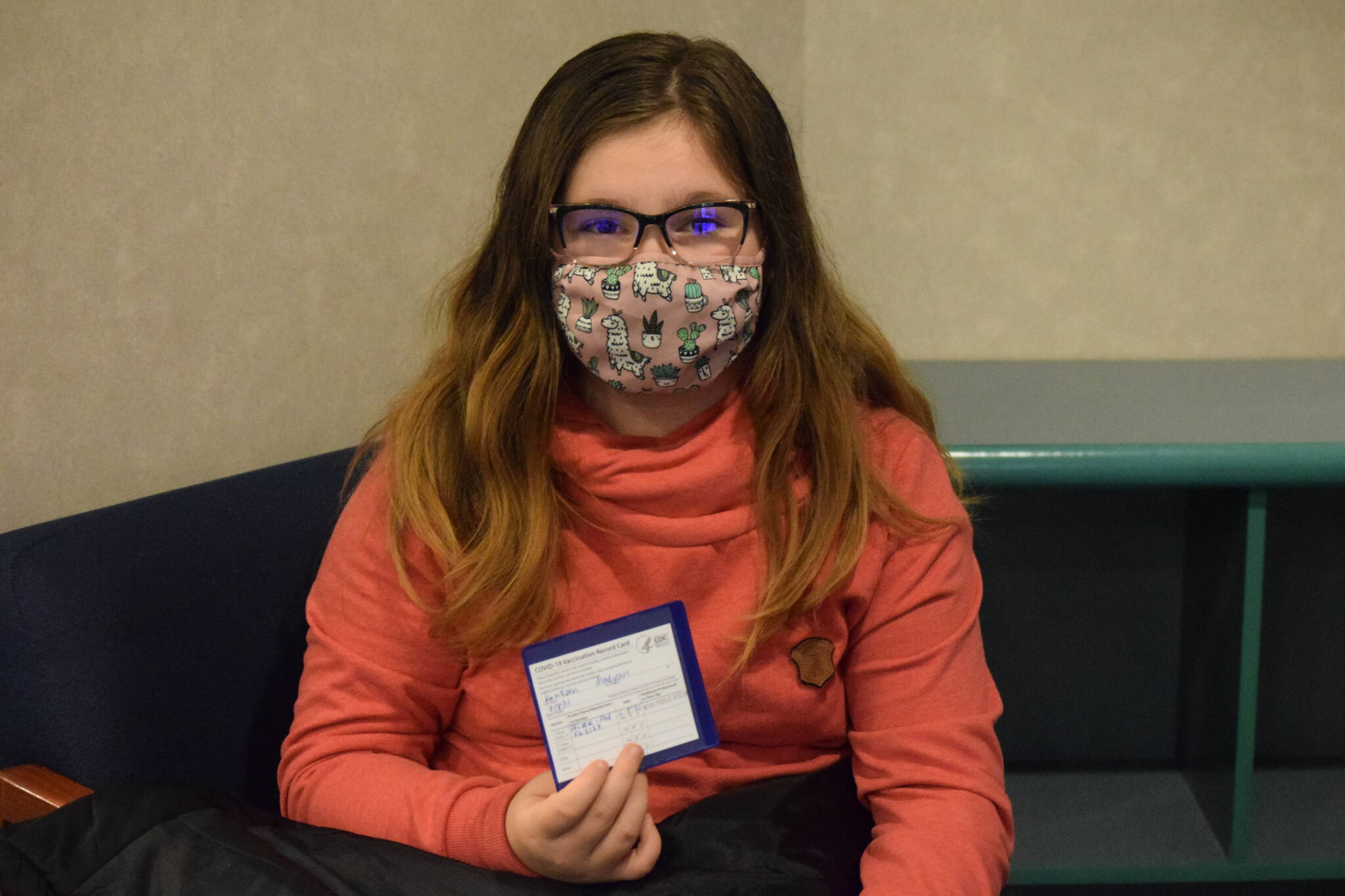 Madyson Knudsen, 10, holds up her COVID-19 vaccine card after receiving her first pediatric shot the Kenai Public Health Center on Friday, Nov. 5, 2021. The Centers for Disease Control and Prevention extended the emergency use authorization of the Pfizer-BioNTech vaccine to include kids ages 5 to 11 this week. (Camille Botello/Peninsula Clarion)