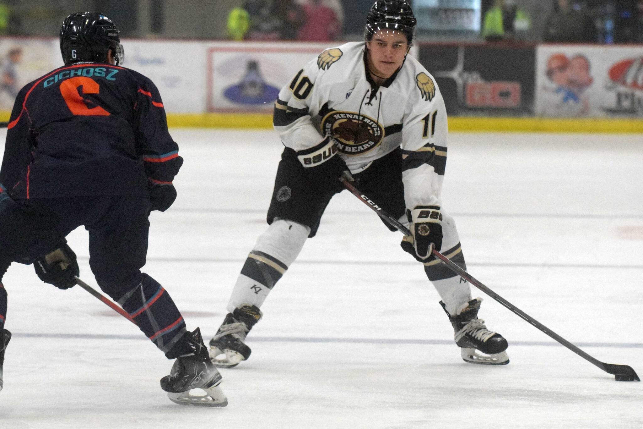 Kenai River Brown Bears forward Caden Triggs carries the puck against Anchorage Wolverines defenseman Campbell Cichosz on Friday, Nov. 5, 2021, at the Soldotna Regional Sports Complex in Soldotna, Alaska. (Photo by Jeff Helminiak/Peninsula Clarion)