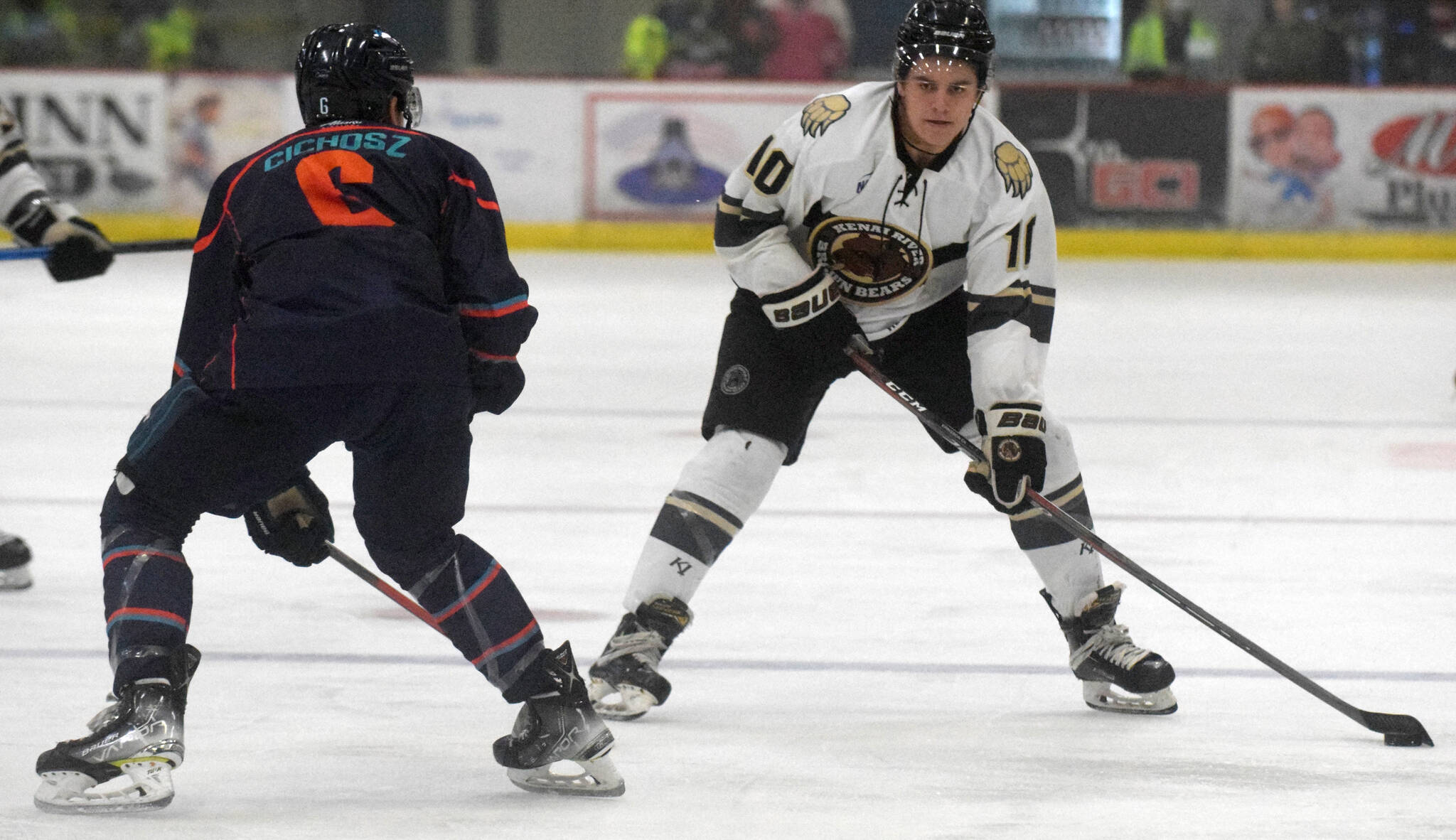 Kenai River Brown Bears forward Caden Triggs carries the puck against Anchorage Wolverines defenseman Campbell Cichosz on Friday, Nov. 5, 2021, at the Soldotna Regional Sports Complex in Soldotna, Alaska. (Photo by Jeff Helminiak/Peninsula Clarion)