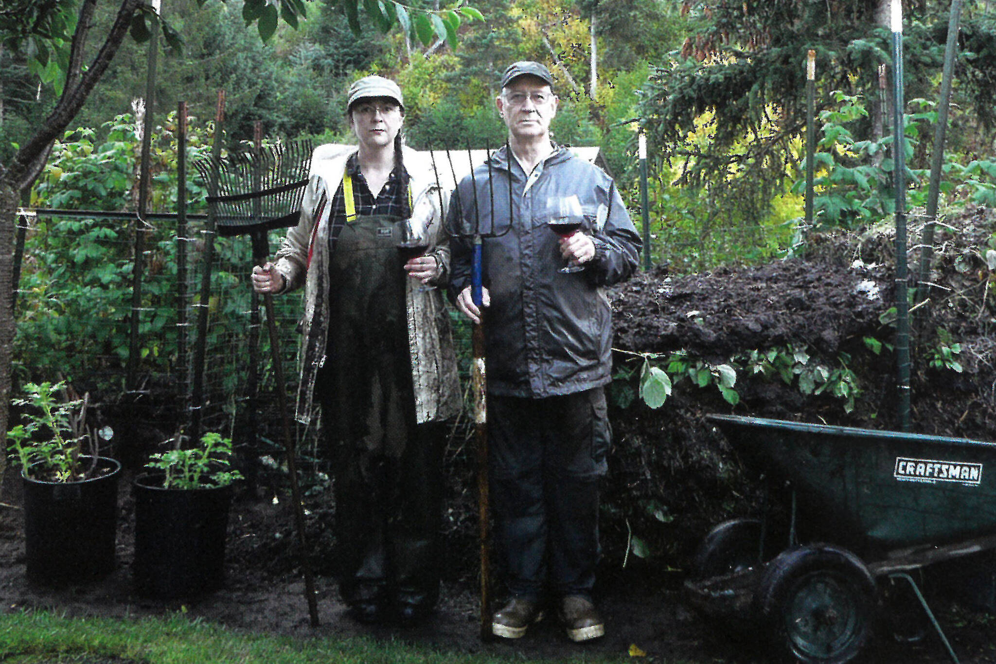 Shelli and Mike Gordon pose in October 2011 at their Halibut Cove, Alaska, home in an Alaska Gothic version of Grant Wood’s “American Gothic” painting. (Photo courtesy of Mike Gordon)