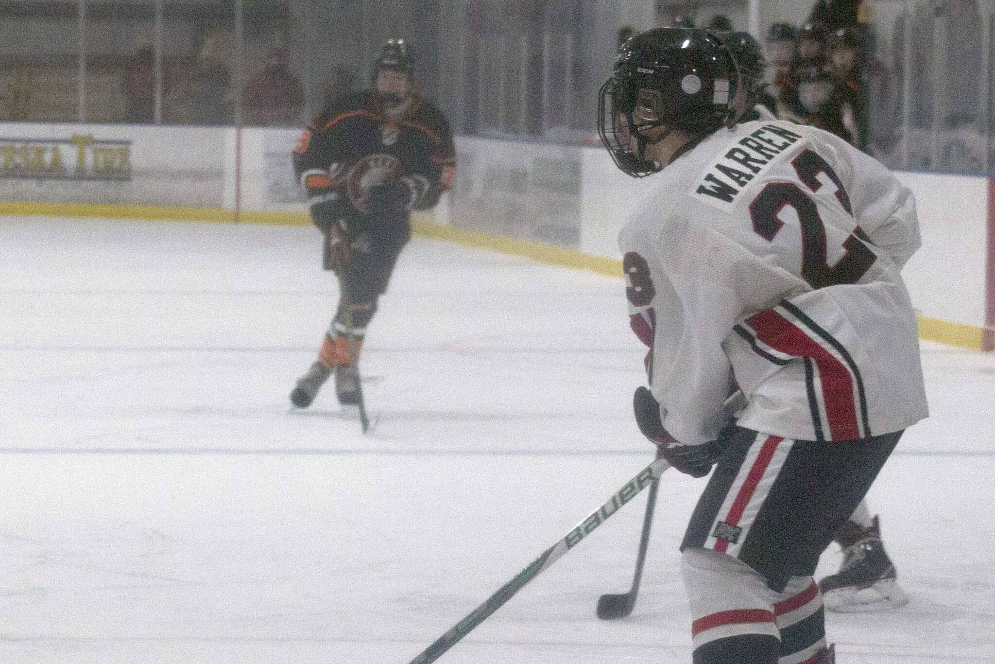 Kenai Central's Caden Warren surveys the ice against West at the End of the Road Tournament at Kevin Bell Arena in Homer, Alaska. (Photo by Sarah Knapp/Homer News)