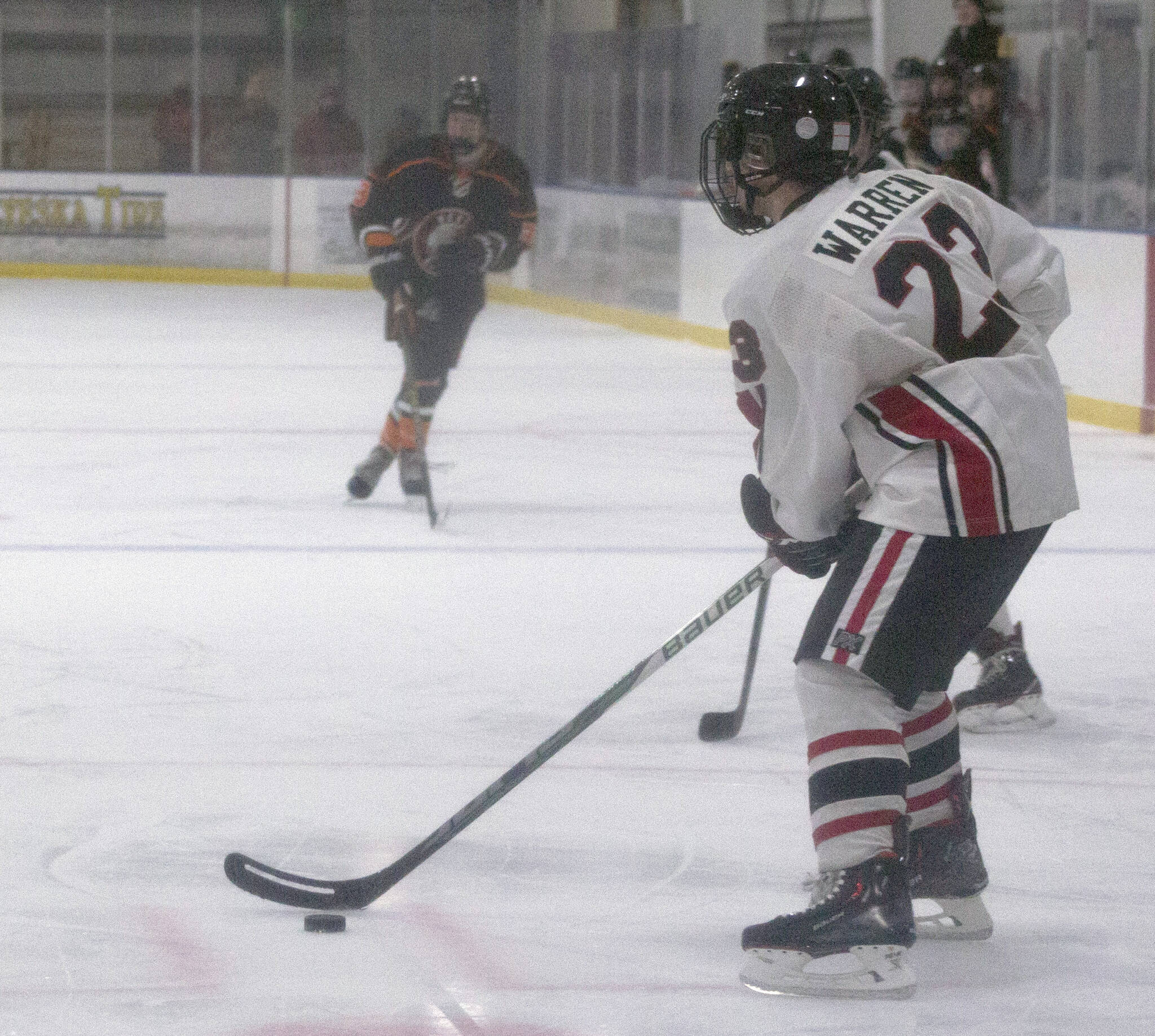 Kenai Central’s Caden Warren surveys the ice against West at the End of the Road Tournament at Kevin Bell Arena in Homer, Alaska. (Photo by Sarah Knapp/Homer News)