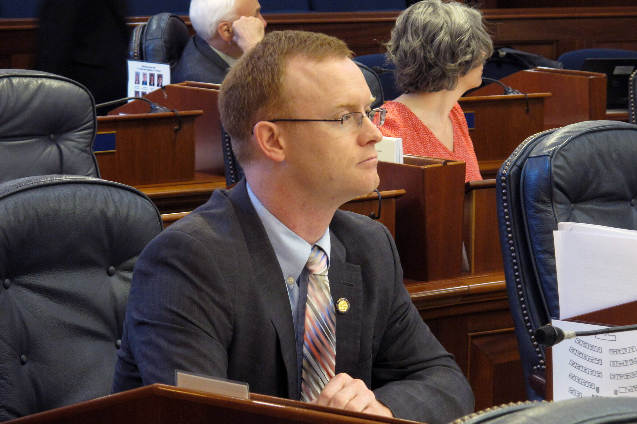 Alaska Rep. David Eastman sits at his desk on the Alaska House floor in Juneau, Alaska, on March 5, 2020. Dozens of West Point graduates have demanded state Rep. Eastman resign from office over his ties to a right wing extremist group, saying his affiliation has betrayed the values of the U.S. Military Academy he attended. (AP Photo/Becky Bohrer, File)