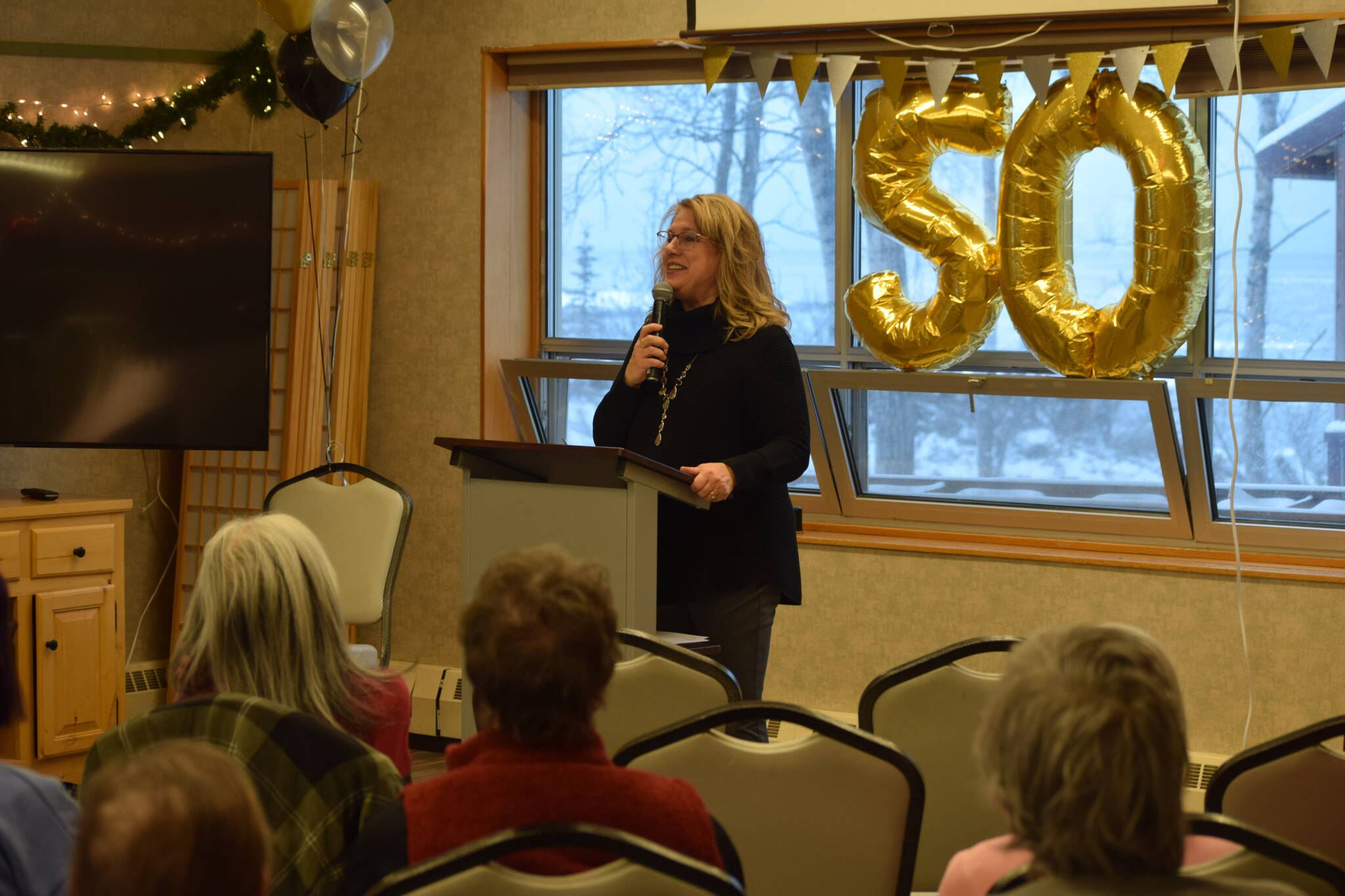 Kathy Romain, the executive director of the Kenai Senior Center, hosts a reception on Tuesday, Nov. 30, 2021 to celebrate the facility’s 50 years in Kenai, Alaska. (Camille Botello/Peninsula Clarion)