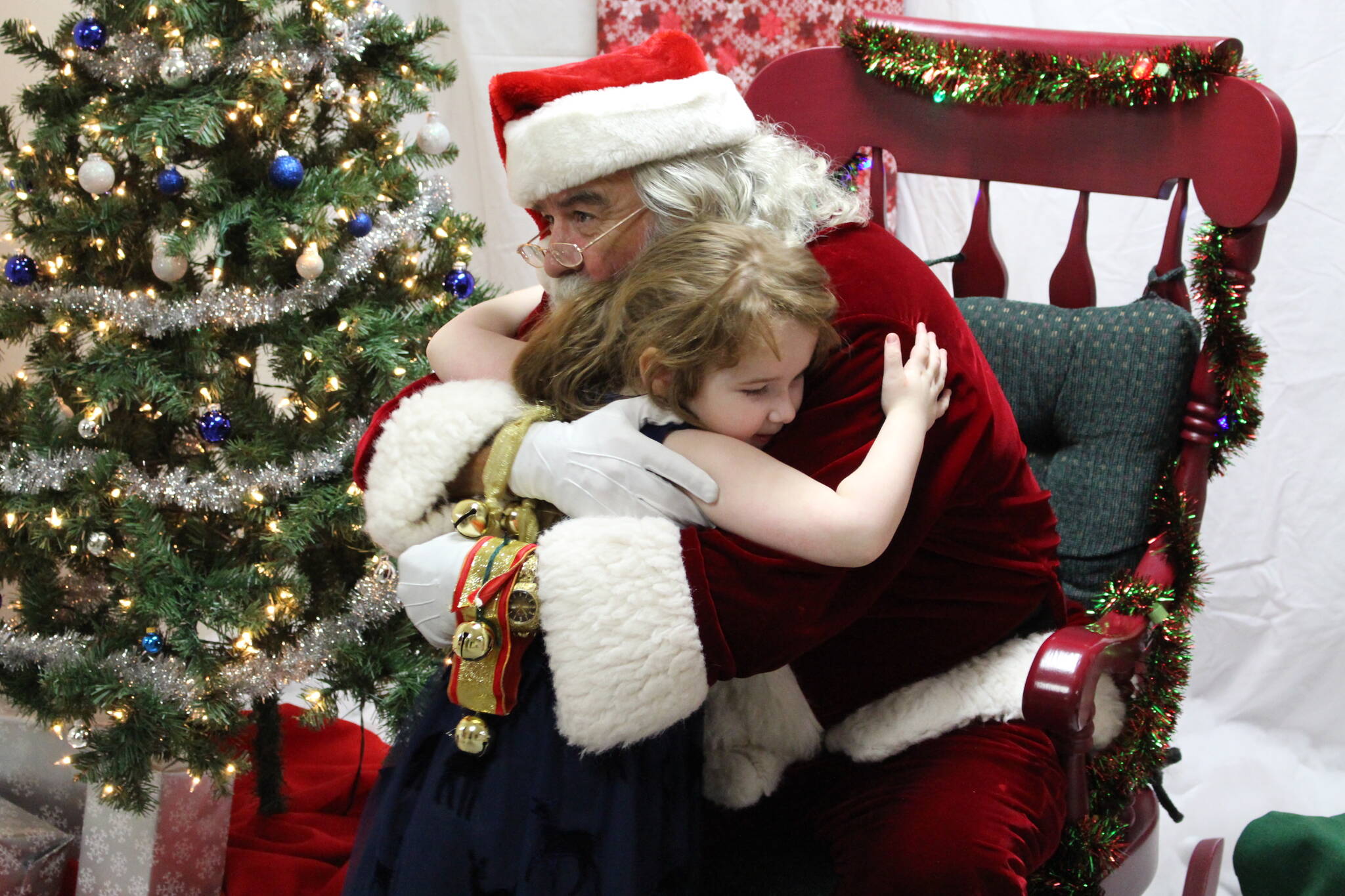 Genna Stormer gives Santa a hug during Christmas Comes to Nikiski at the Nikiski Community Recreation Center on Dec. 14, 2019. (Photo by Brian Mazurek/Peninsula Clarion)