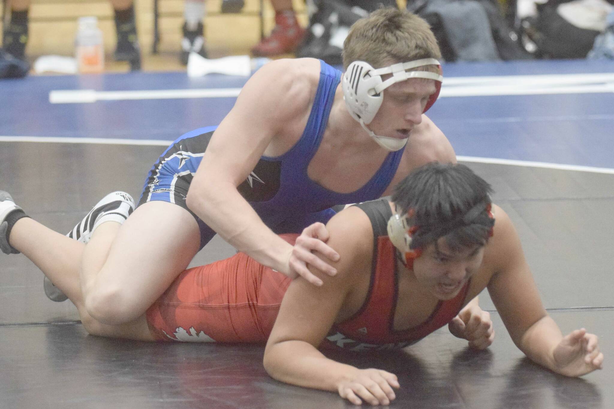 Soldotna's Wayne Mellon works to a pin of Kenai Central's Zoticus Active at 189 pounds in a dual meet at Soldotna High School on Tuesday, Nov. 30, 2021, in Soldotna, Alaska. (Photo by Jeff Helminiak/Peninsula Clarion)