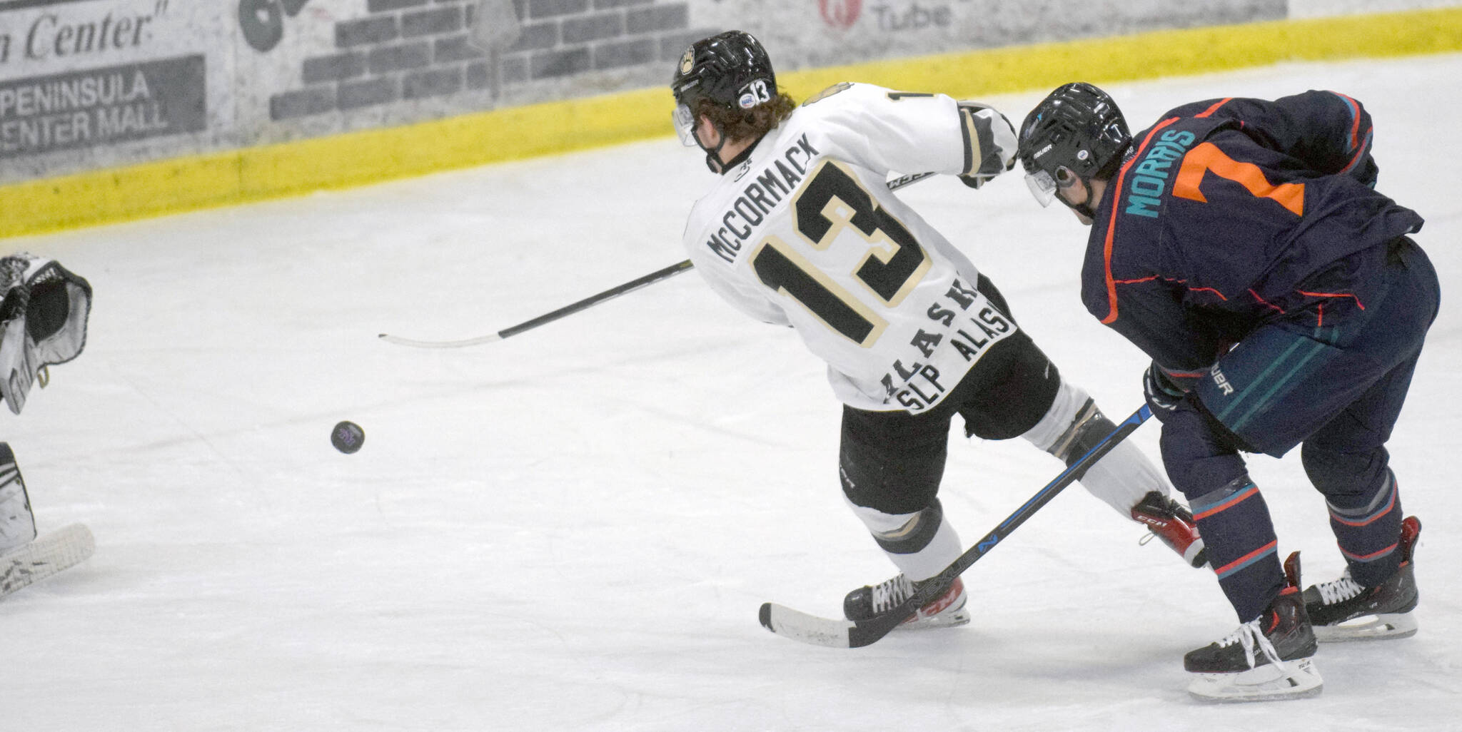 Gramm McCormack of the Kenai River Brown Bears earns a penalty shot after getting tripped up by Cooper Morris of the Anchorage Wolverines on Friday, Dec. 3, 2021, at the Soldotna Regional Sports Complex in Soldotna, Alaska. (Photo by Jeff Helminiak/Peninsula Clarion)