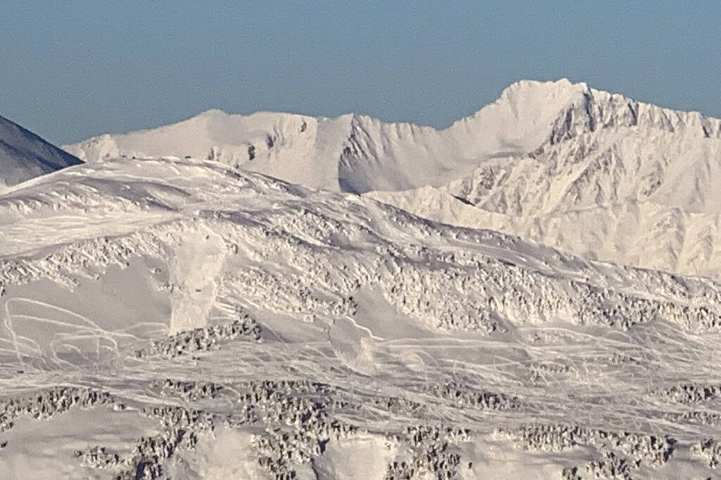 Two snowmachine-triggered snow slabs are seen below the weather station of Seattle Ridge in Turnagain Pass on Dec. 3, 2021. (Photo courtesy of Chris Flowers and the Chugach Avalanche Center)
