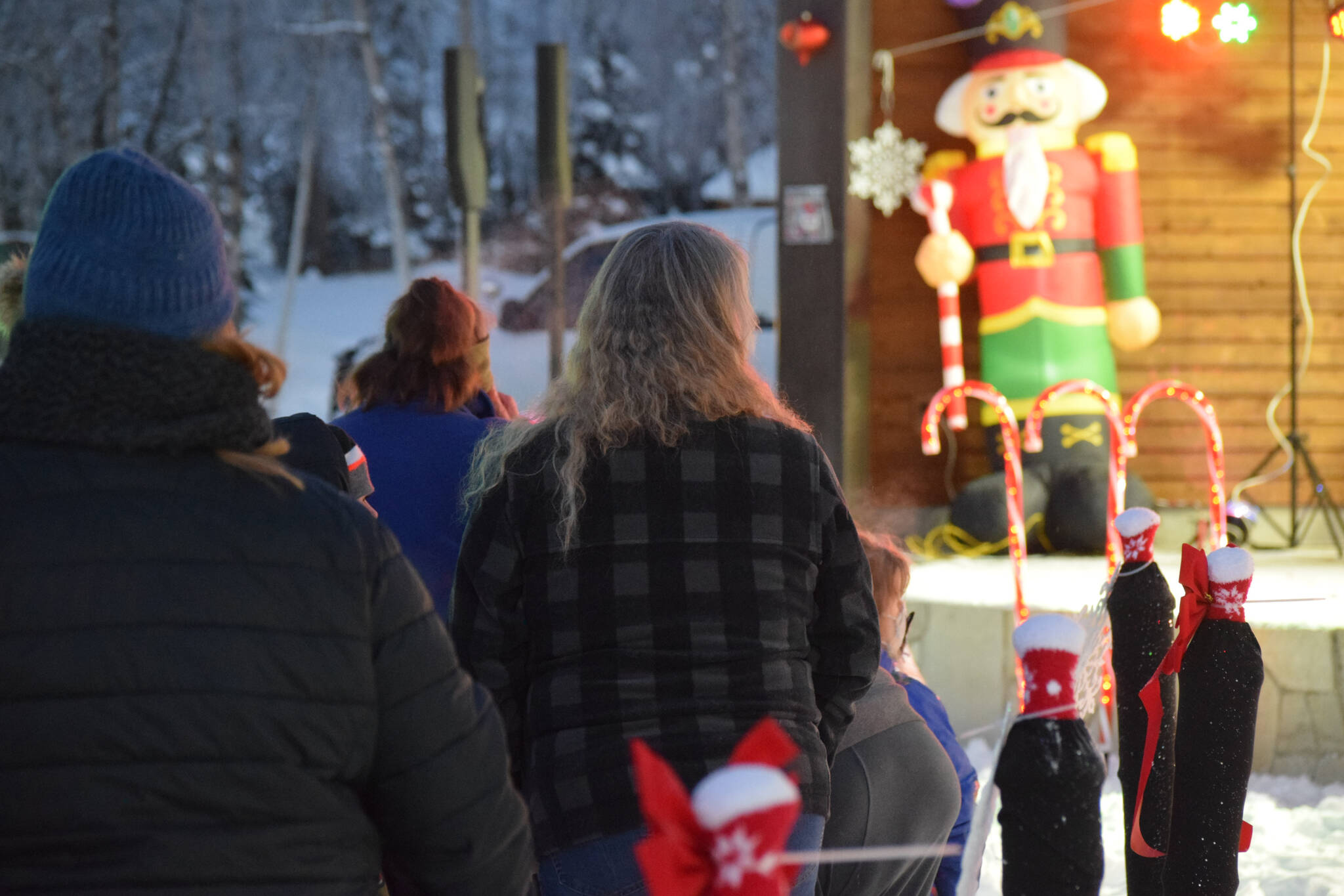 People wait in line to take photos with Santa at Soldotna Creek Park on Saturday, Dec. 4, 2021. (Camille Botello/Peninsula Clarion)