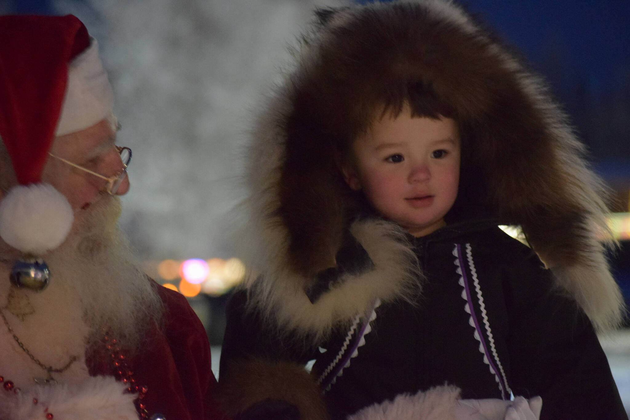 Danny Dommek takes photos with Santa at Soldotna Creek Park on Saturday, Dec. 4, 2021. (Camille Botello/Peninsula Clarion)